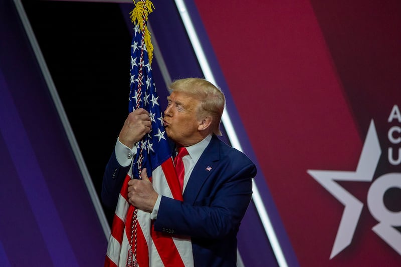 NATIONAL HARBOR, MARYLAND - FEBRUARY 29: President Donald Trump kisses the flag of the United States of America at the annual Conservative Political Action Conference (CPAC) at Gaylord National Resort & Convention Center February 29, 2020 in National Harbor, Maryland. Conservatives gather at the annual event to discuss their agenda. (Photo by Tasos Katopodis/Getty Images)
