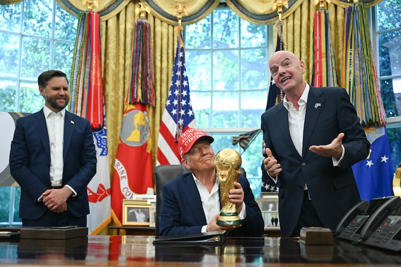 President Donald Trump was all smiles when he got to briefly hold the FIFA World Cup trophy in the Oval Office on Friday.