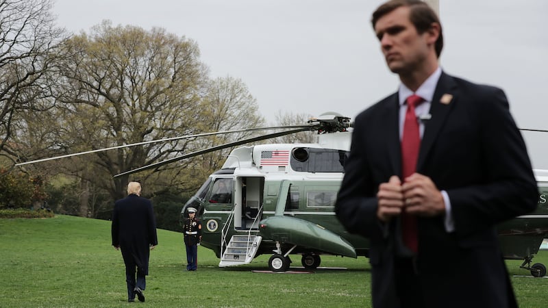 WASHINGTON, DC - APRIL 05: A U.S. Secret Service agent stands watch as President Donald Trump walks across the South Lawn before boarding Marine One at the White House April 05, 2019 in Washington, DC. Trump is traveling to Southern California to visit the U.S.-Mexico border and to Beverly Hills for a fundraiser. (Photo by Chip Somodevilla/Getty Images)