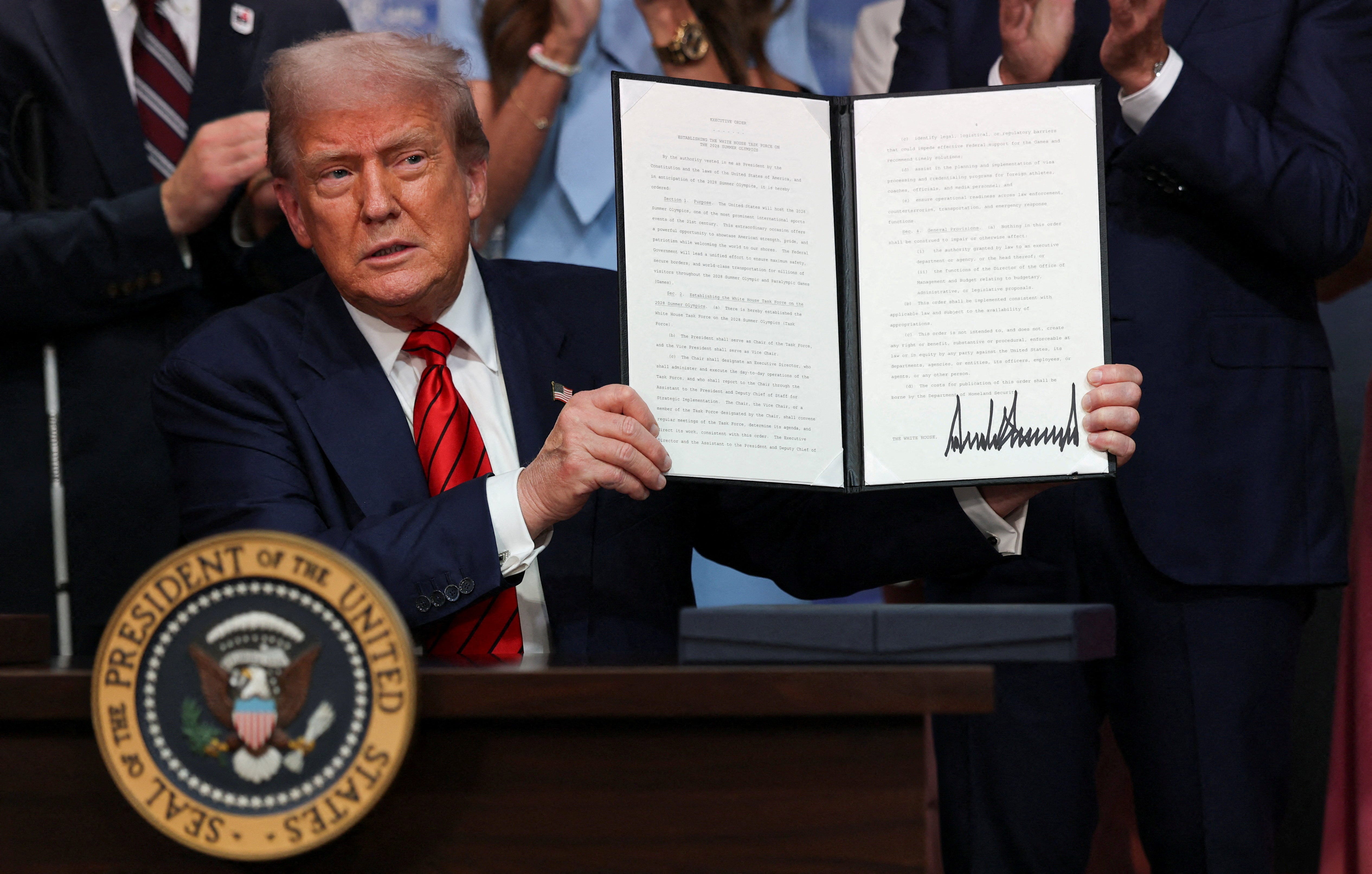 U.S. President Donald Trump signs an executive order, in Washington