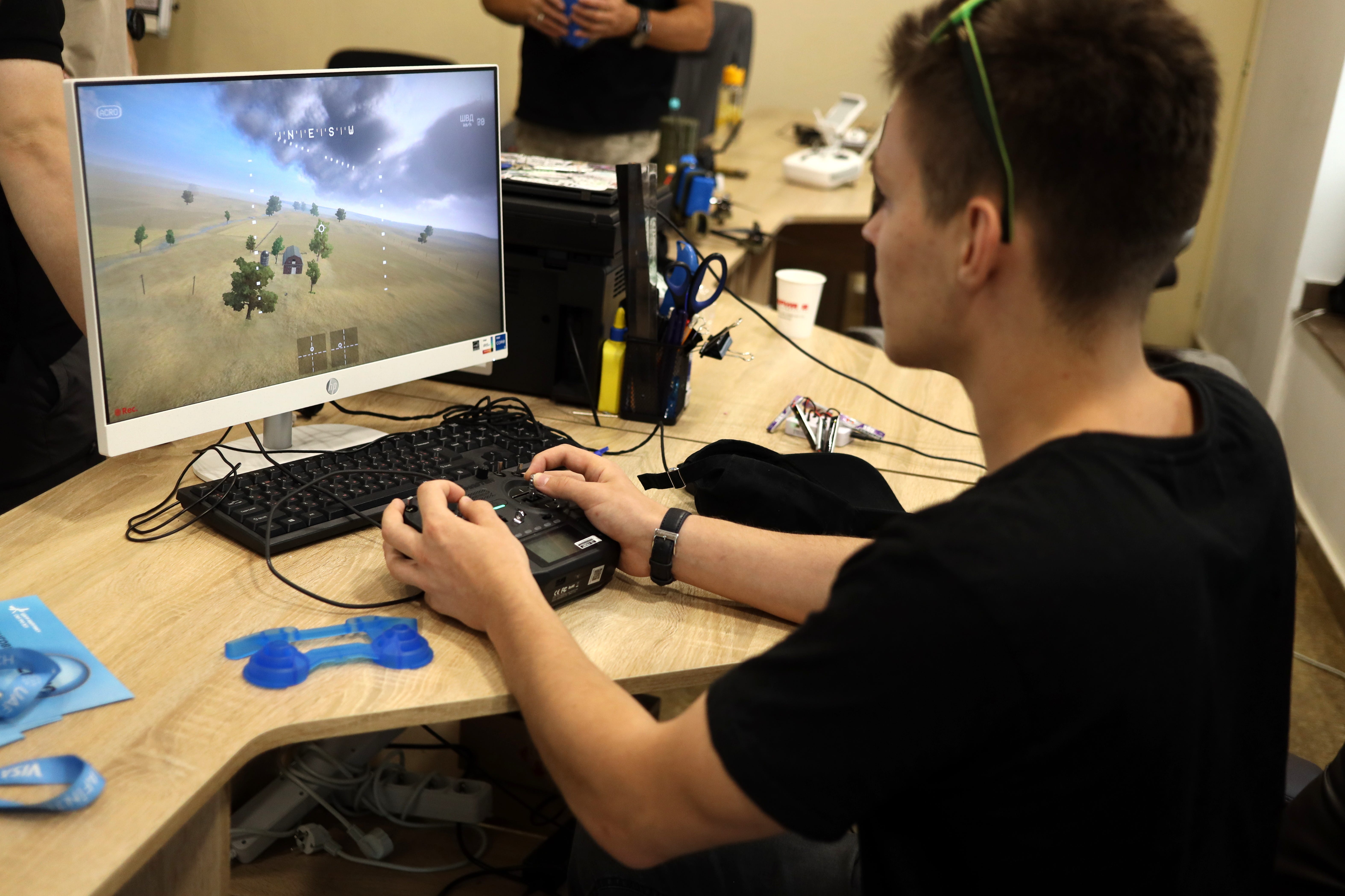 A man practices flying a drone on a simulator during the practical part of the training for civilians 'How to become a drone operator' in Odesa.