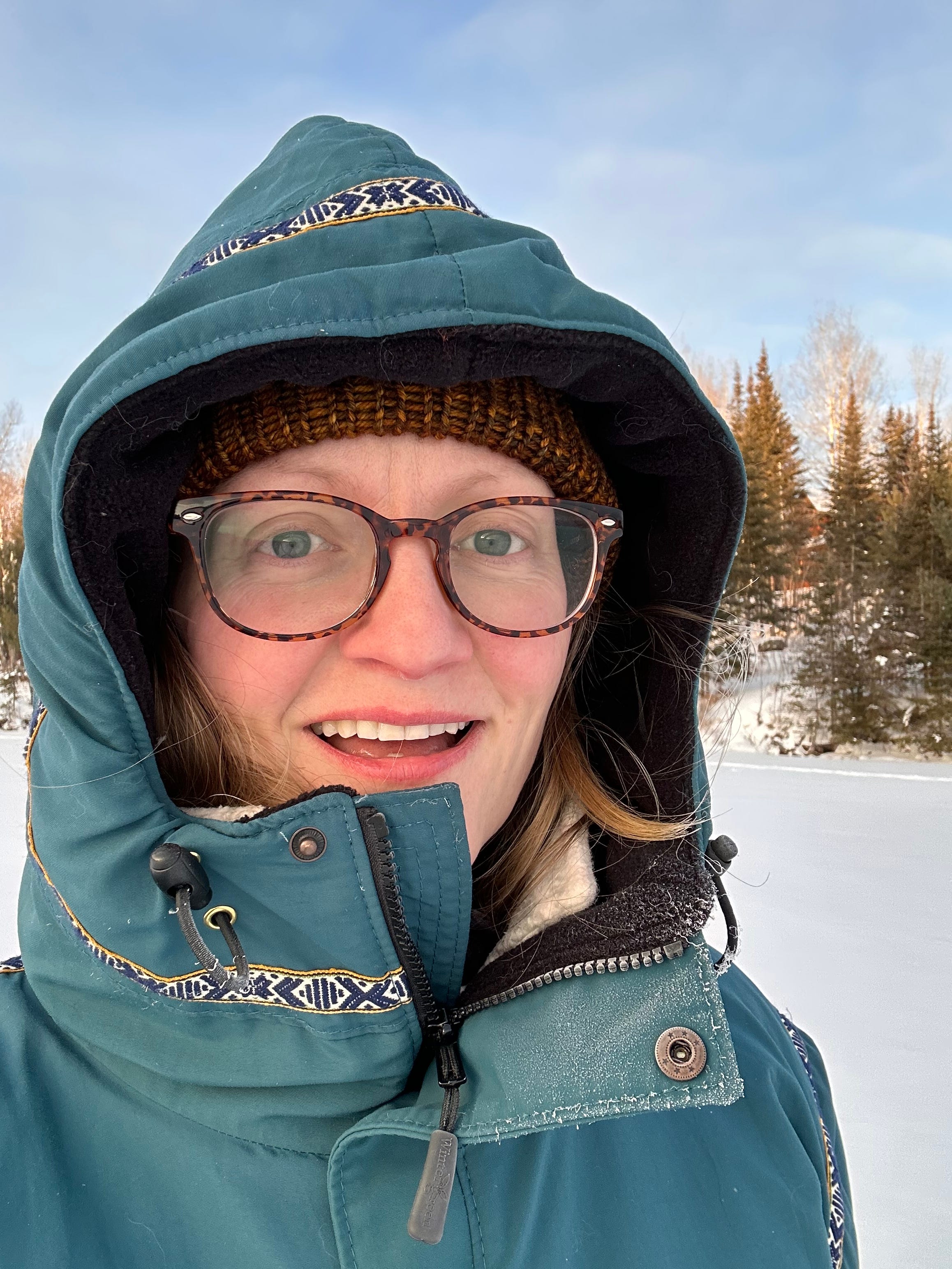woman in winter coat with snow in background