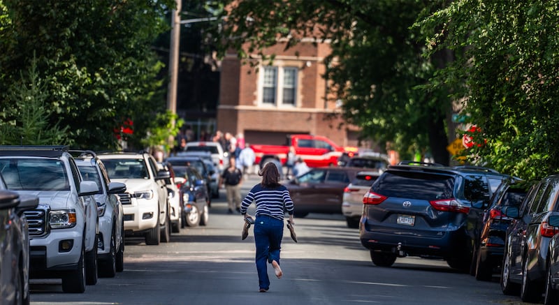 A parent runs toward the school during an active shooter situation at the Annunciation Church in Minneapolis, (Photo by RICHARD TSONG-TAATARII/The Star Tribune via Getty Images)