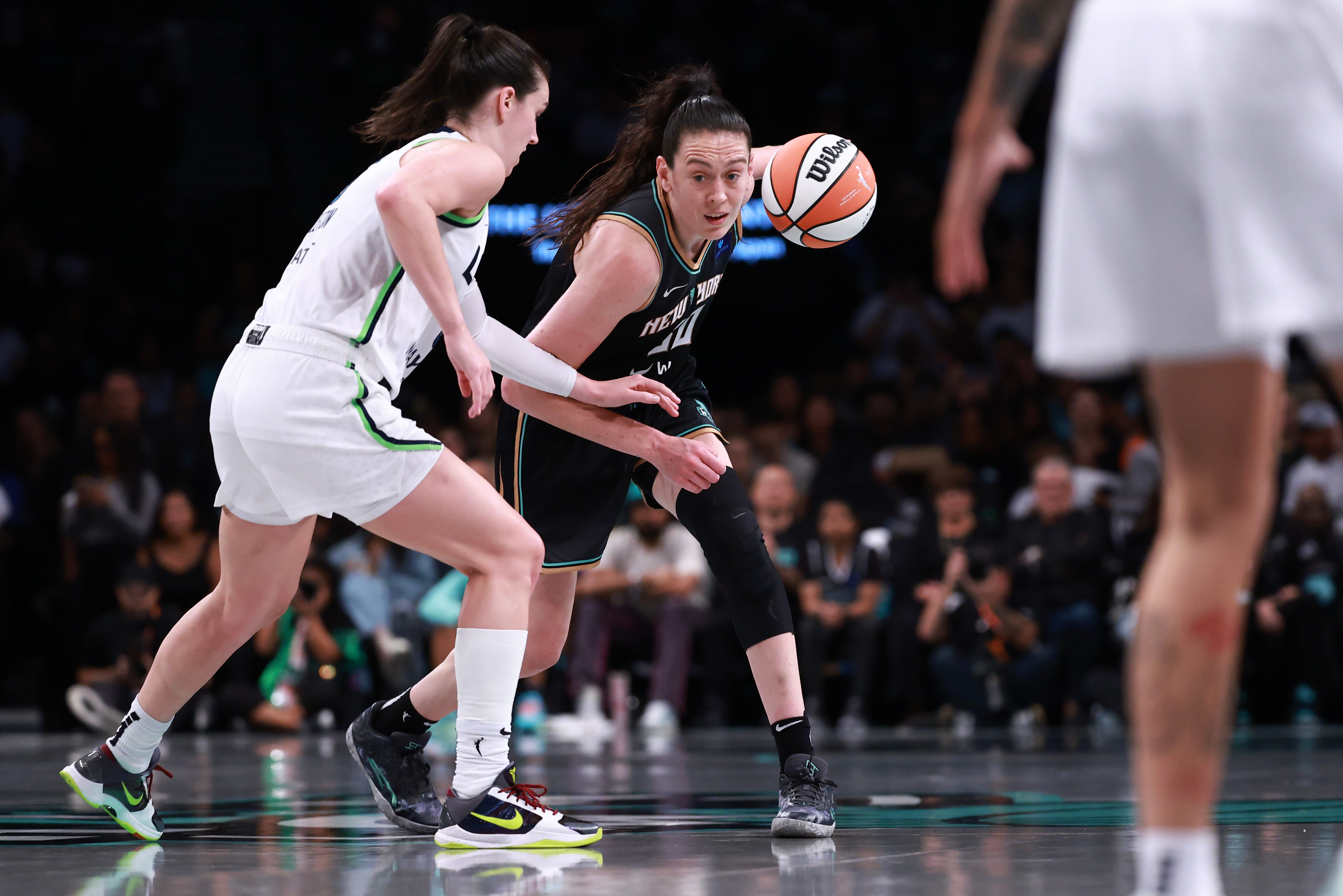 Breanna Stewart of the New York Liberty drives past Bridget Carleton of the Minnesota Lynx with the basketball during Game 2 of the 2024 WNBA Finals.