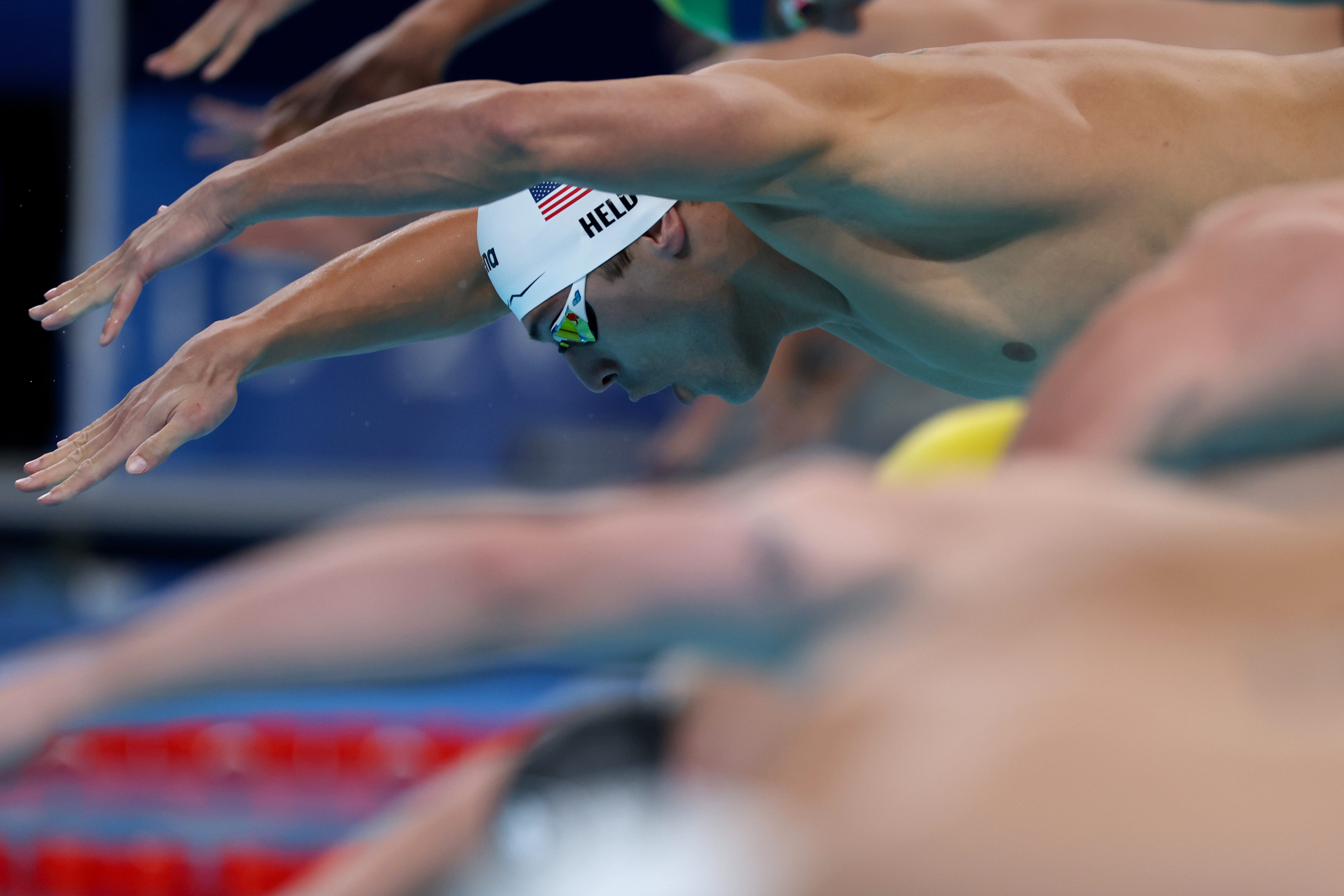 Ryan Held of Team United States competes in the Men's 4x100m Freestyle Relay Heats on day one of the Olympic Games Paris 2024 at Paris La Defense Arena on July 27, 2024 in Nanterre, France.