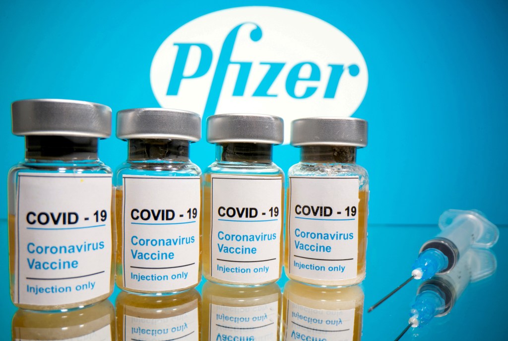 Illustration of Pfizer COVID-19 vaccine vials and a syringe.