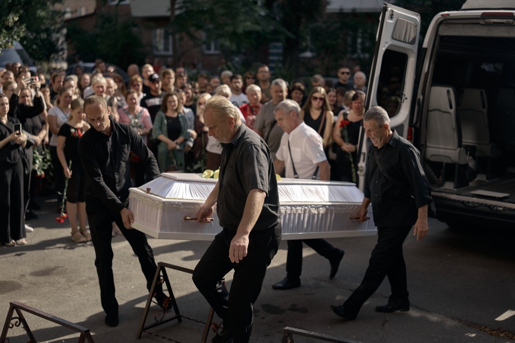 Funeral procession for a mother and daughter killed in a missile strike in Kyiv.