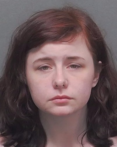 Mugshot of a young woman with dark brown hair.