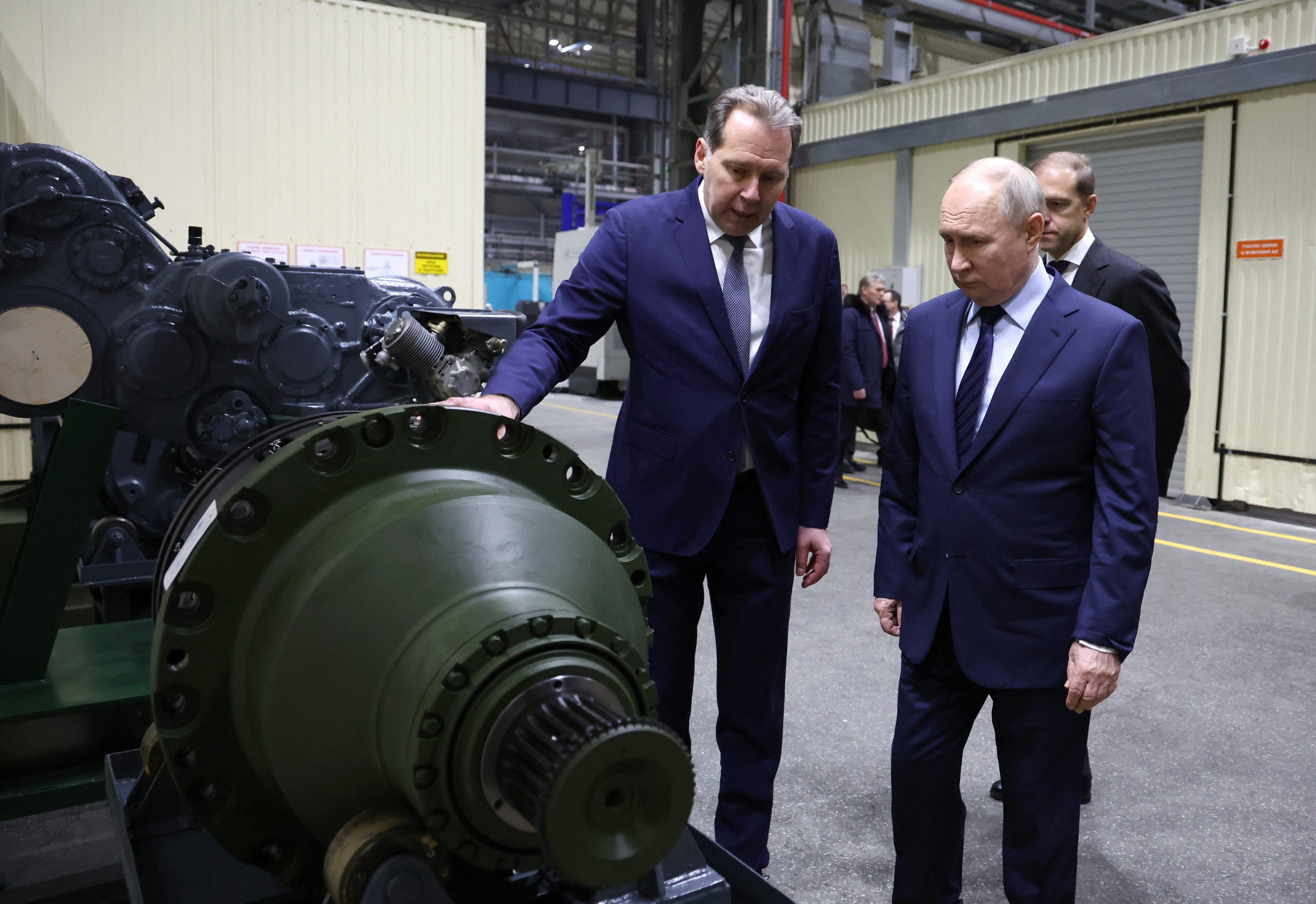 Putin looks at parts for armored vehicles in Uralvagonzavod's main tank factory in the Urals.