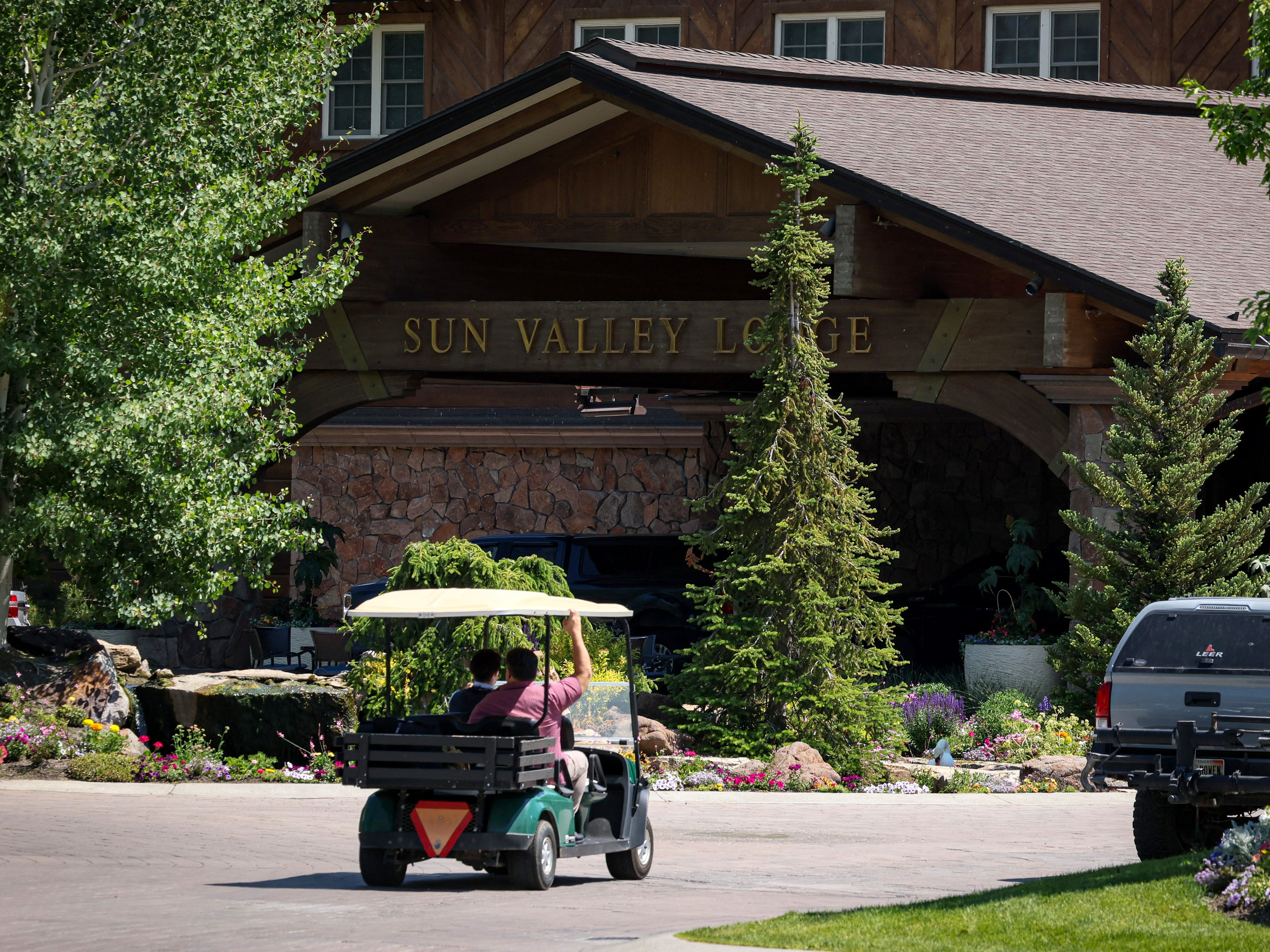 A golf cart riding toward Sun Valley Lodge