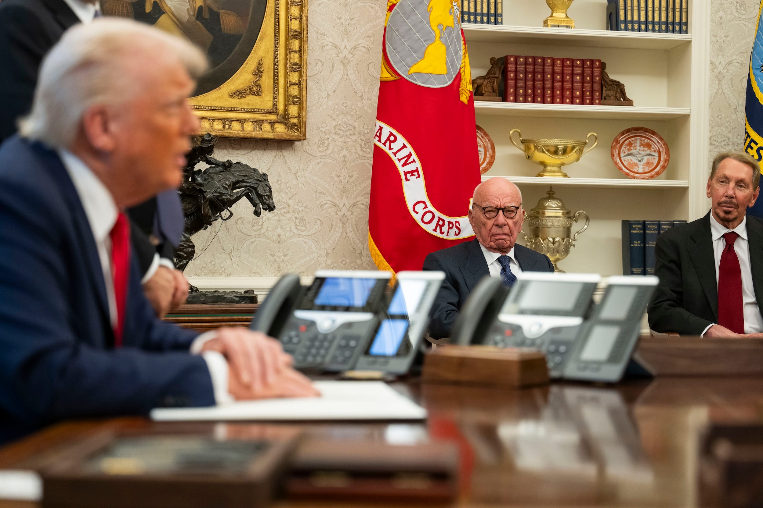 Rupert Murdoch and Larry Ellison look on as Donald Trump talks in the Oval Office