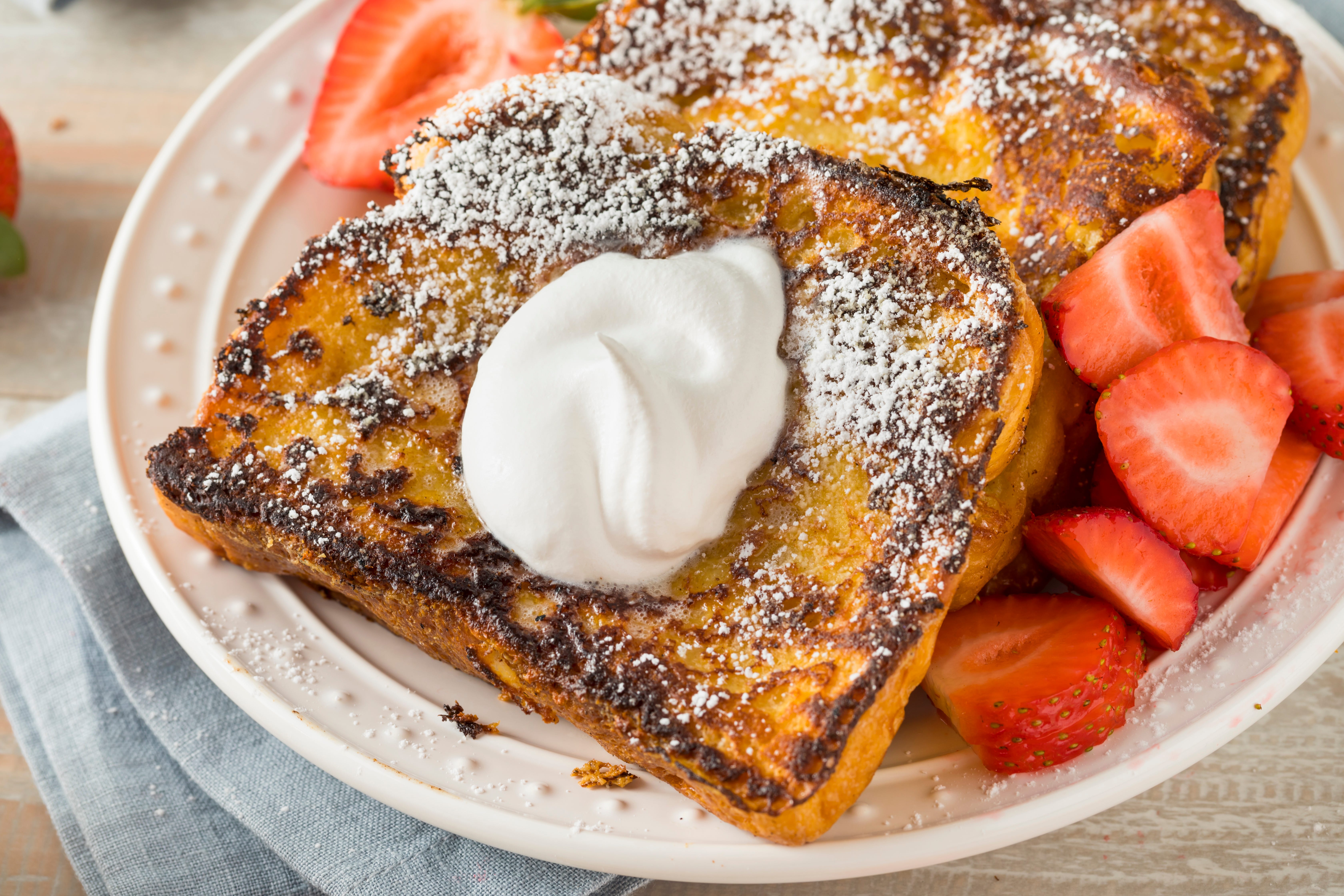 French toast with whipped cream and strawberry slices