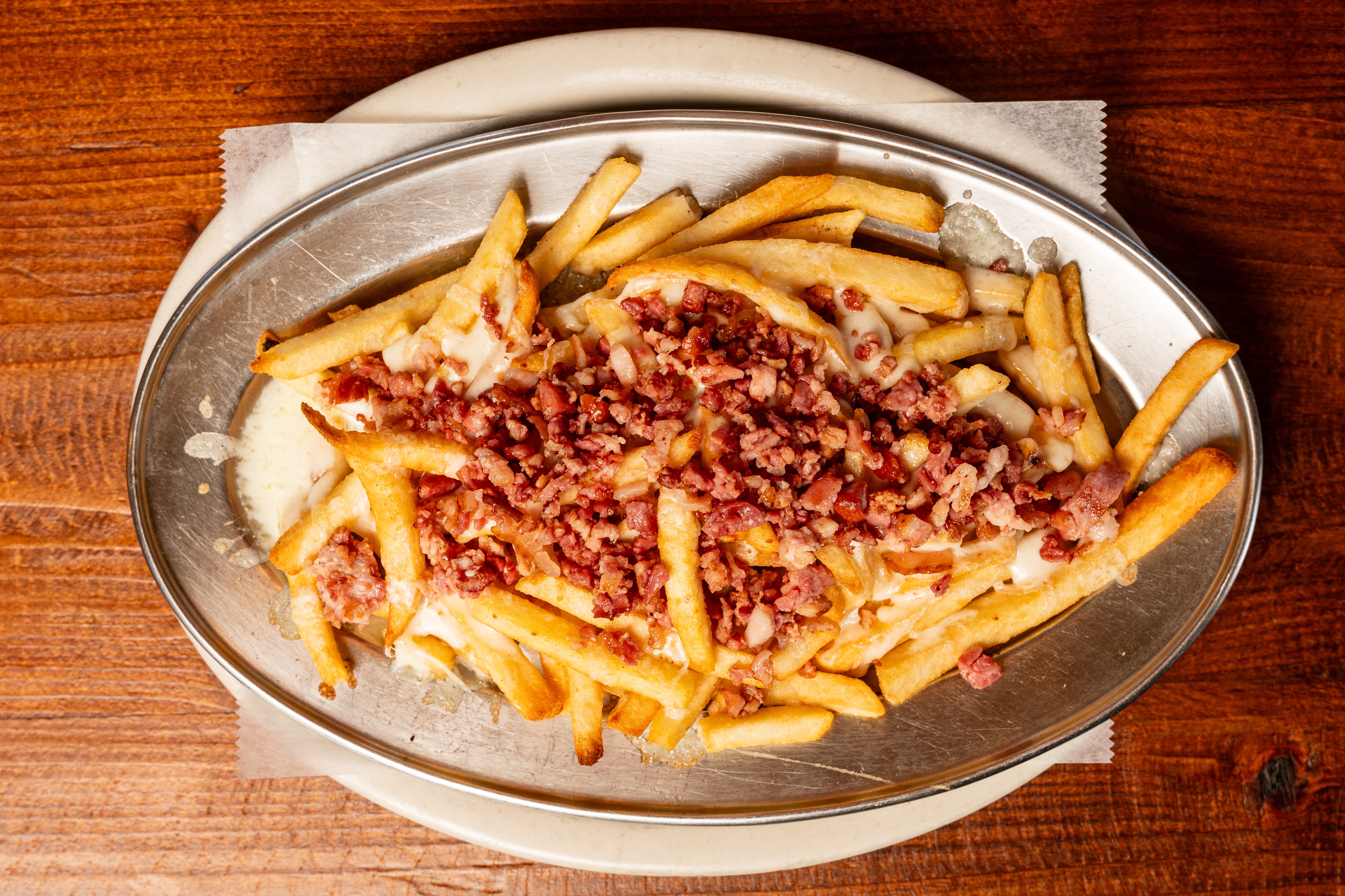 French fries topped with cheese and bacon