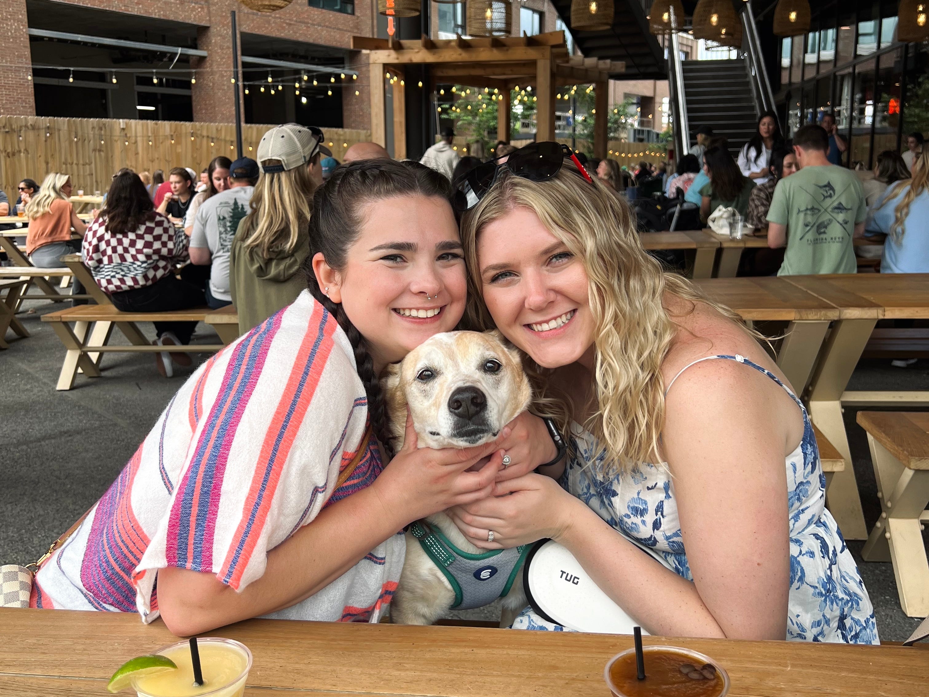 Author Elizabeth Wright smiling with woman and dog in bar