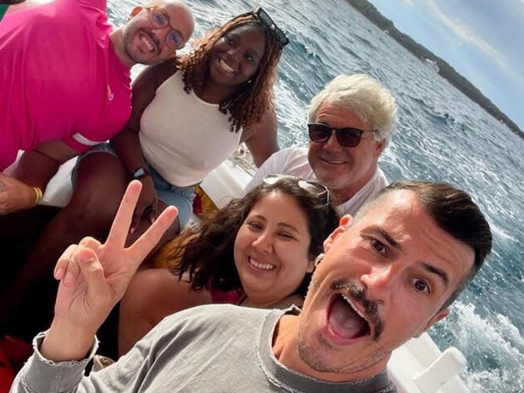 Djena and her friends pose for a photo on a boat.