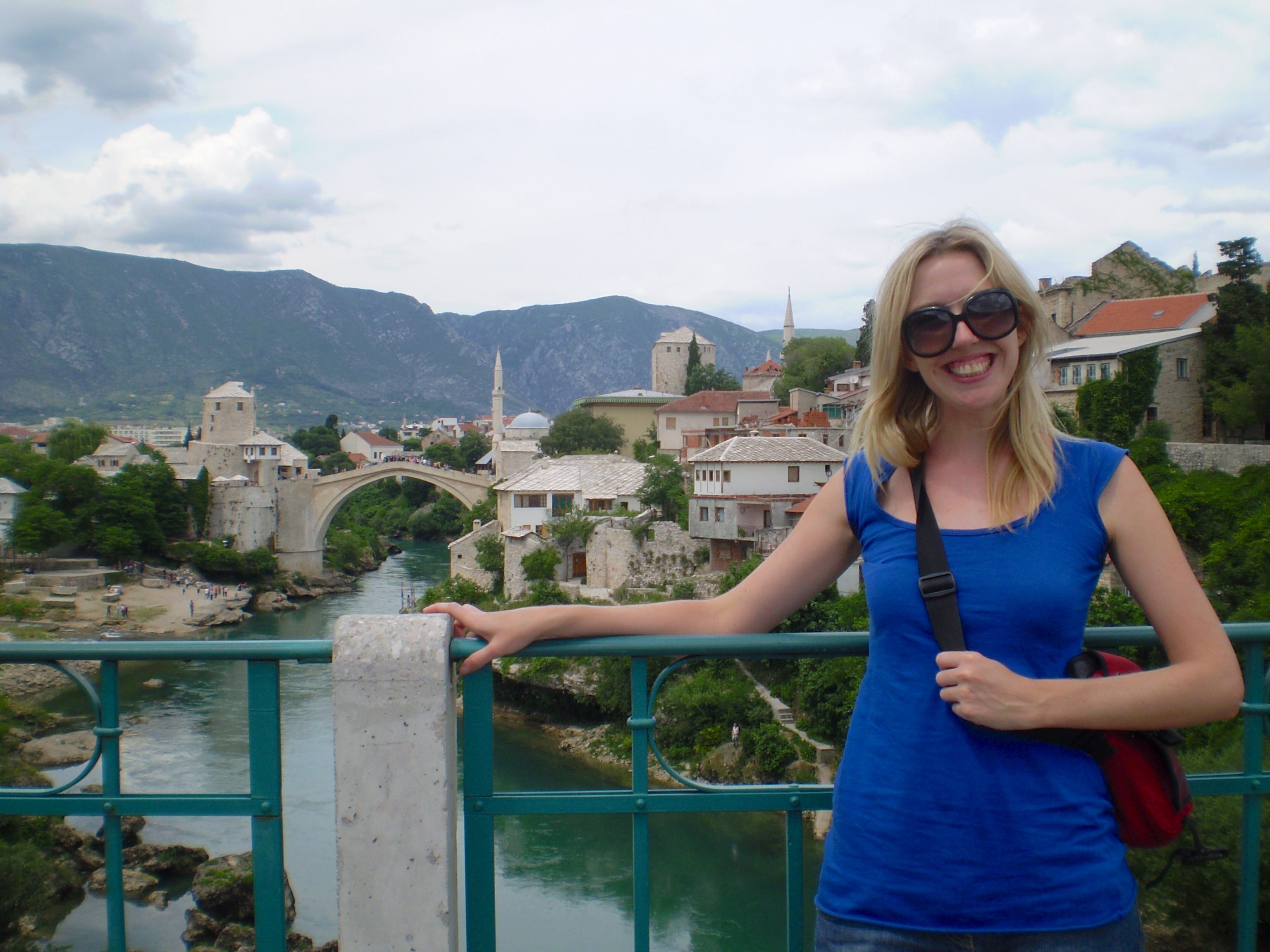 The author poses on a bridge in Bosnia.
