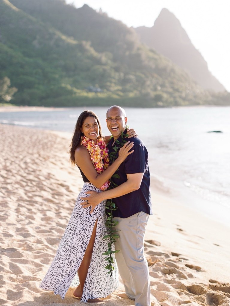 Senator Cory Booker and his fiancée embracing on a beach.