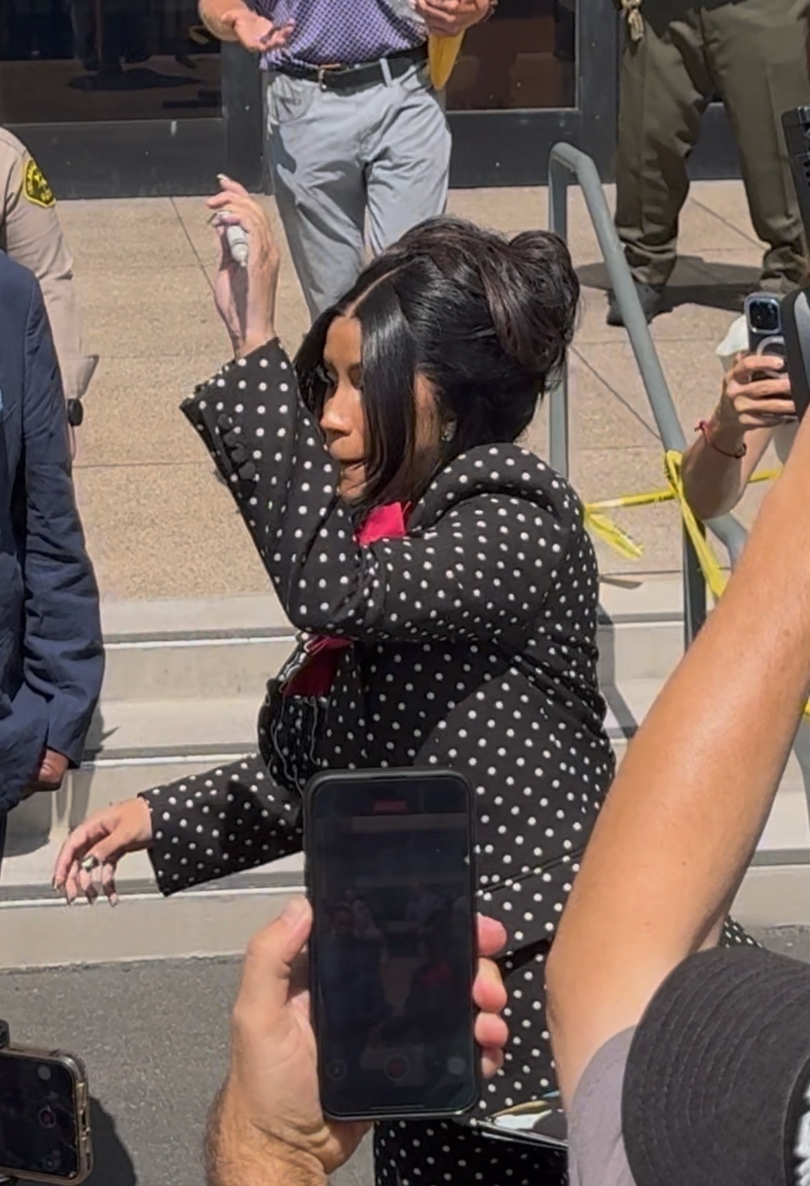 Cardi B throwing a marker outside court. 