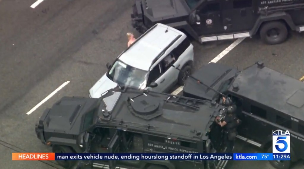 Police surrounding a vehicle with a naked woman.