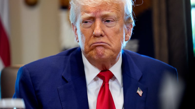 Donald Trump reacts to a question during a Cabinet meeting at the White House.