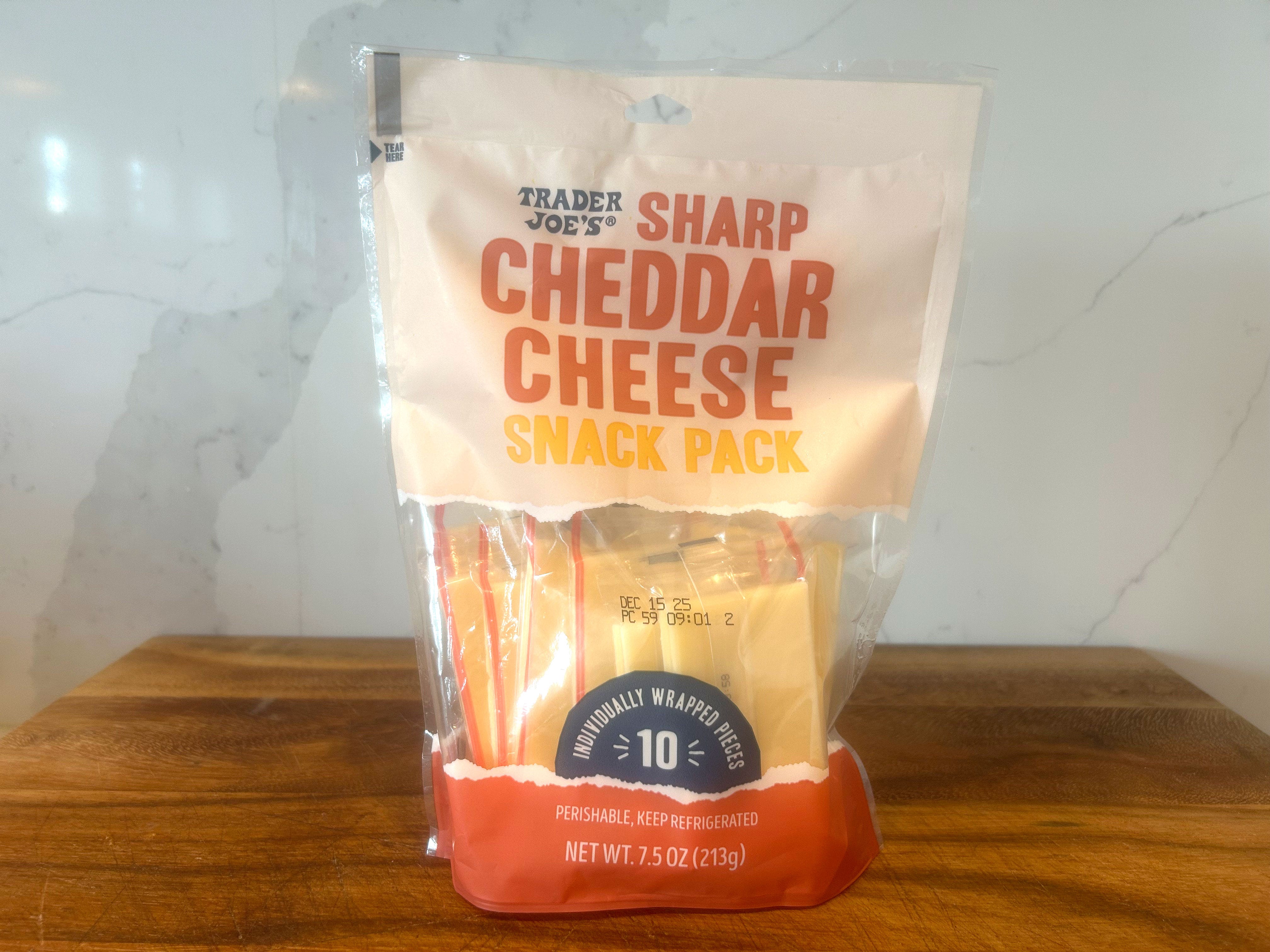 A bag of Trader Joe's sharp cheddar cheese.
