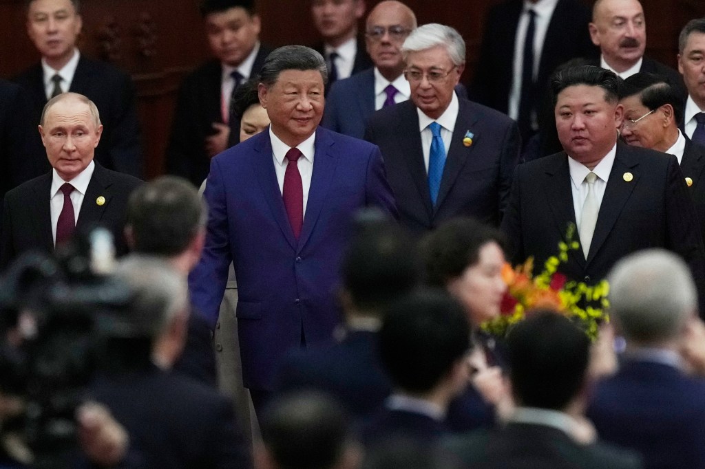 Xi Jinping, Kim Jong Un, and Vladimir Putin at a reception following a military parade.