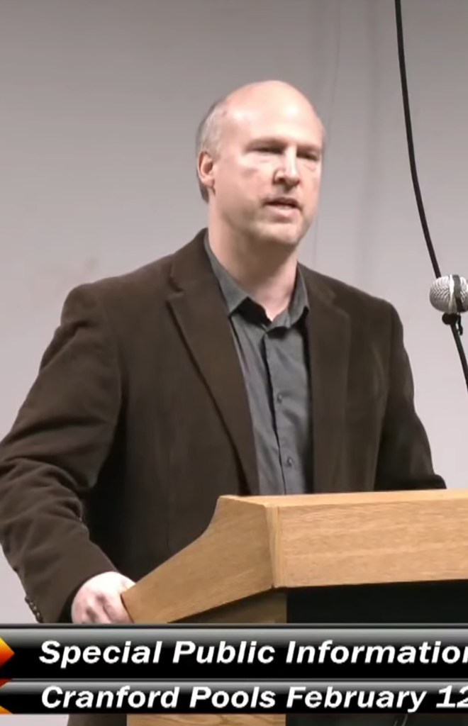 Man speaking at a podium.