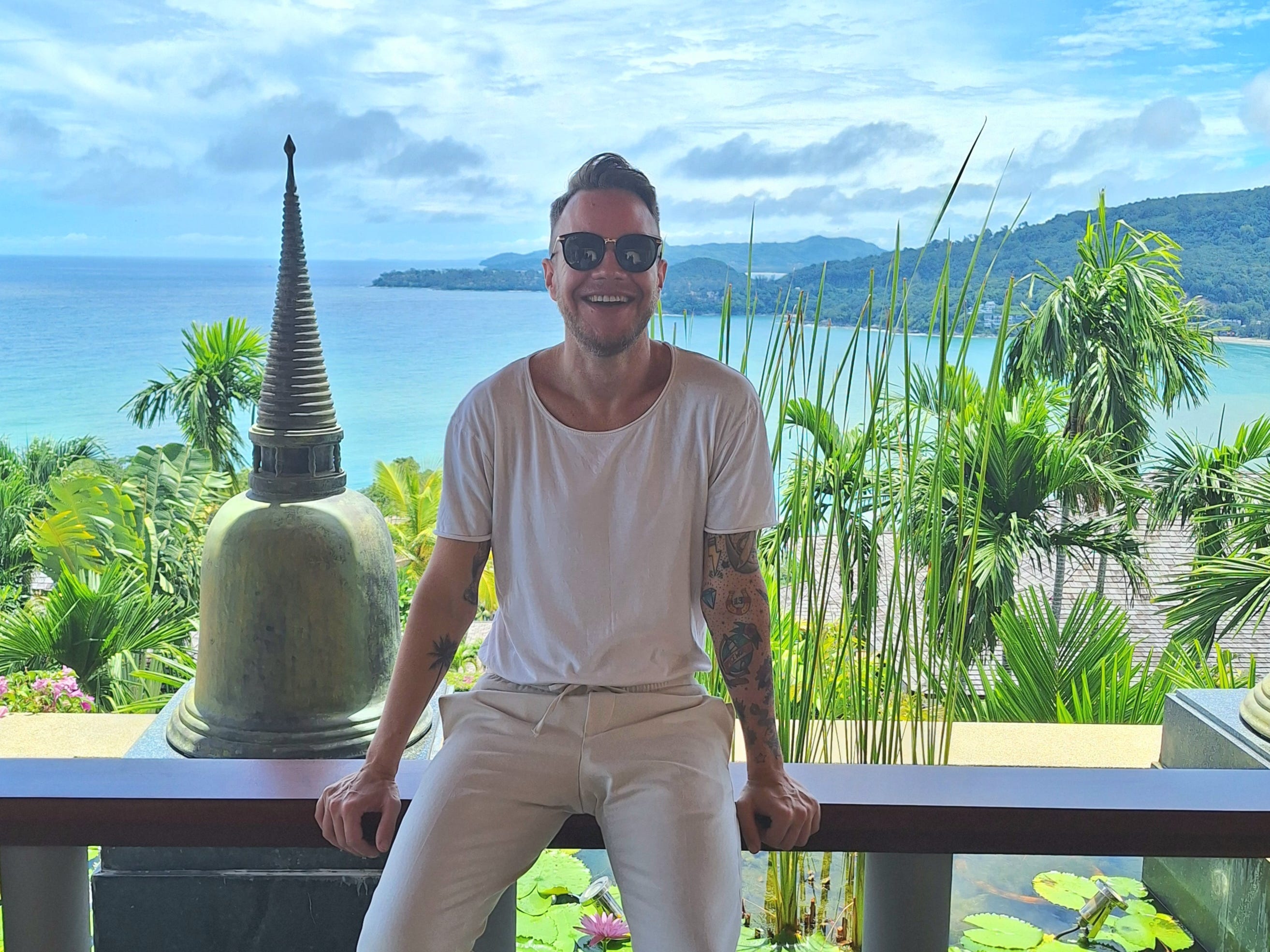Andre Neveling in Thailand posing with the sea in the background.
