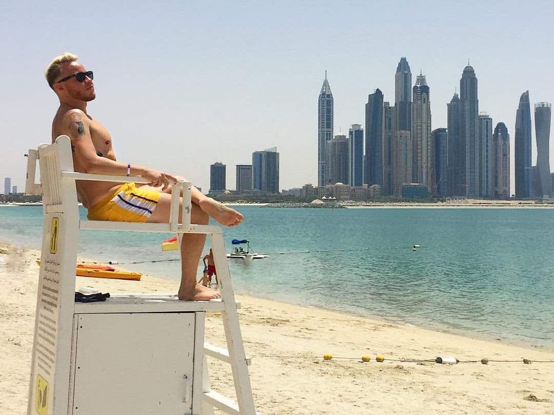 Andre Neveling sitting on a lifeguard chair on a beach in Dubai.
