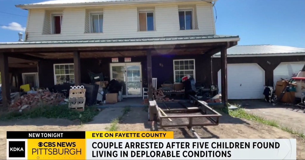 House exterior with debris, where five children were found living in deplorable conditions.