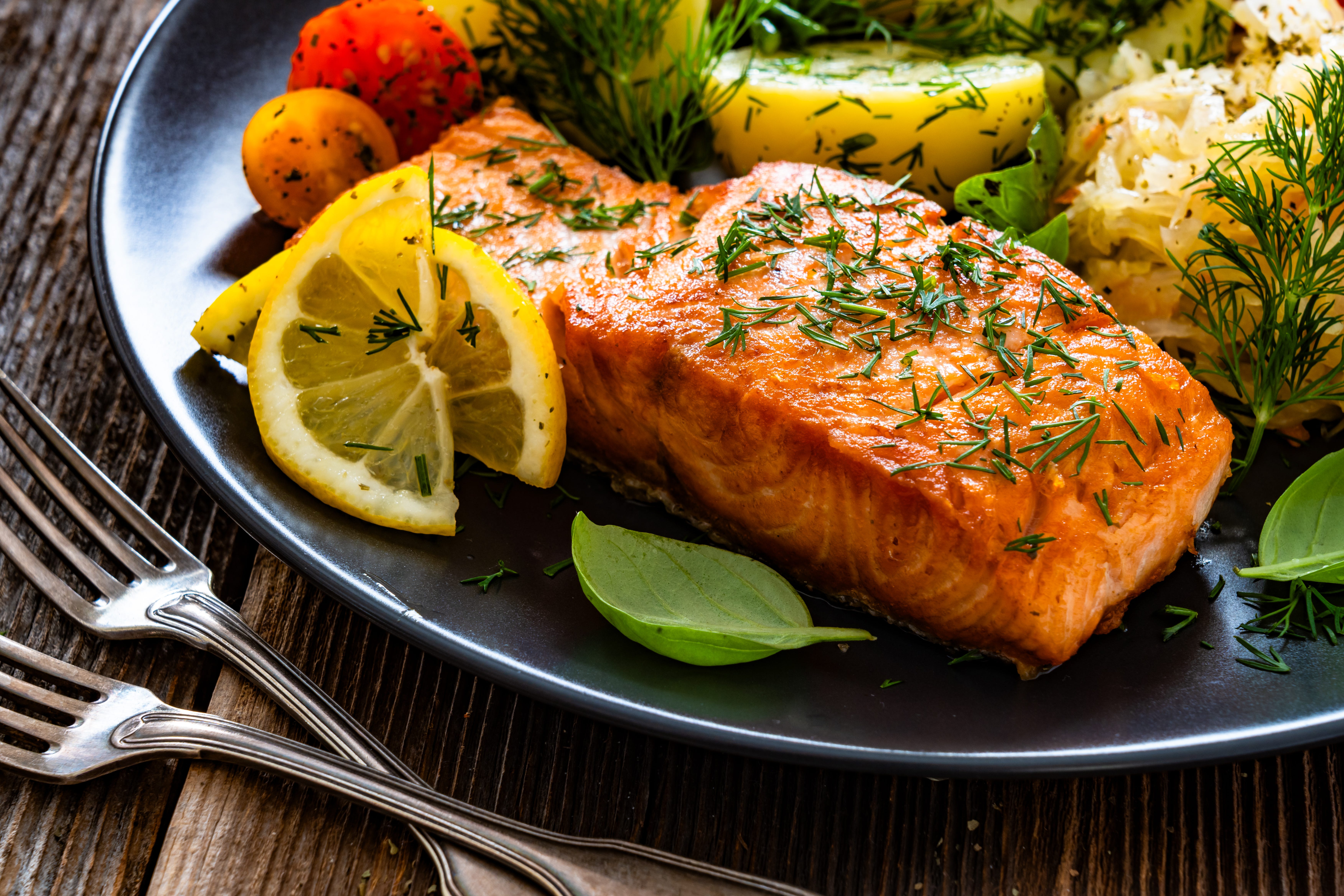 A plate of grilled salmon and vegetables.