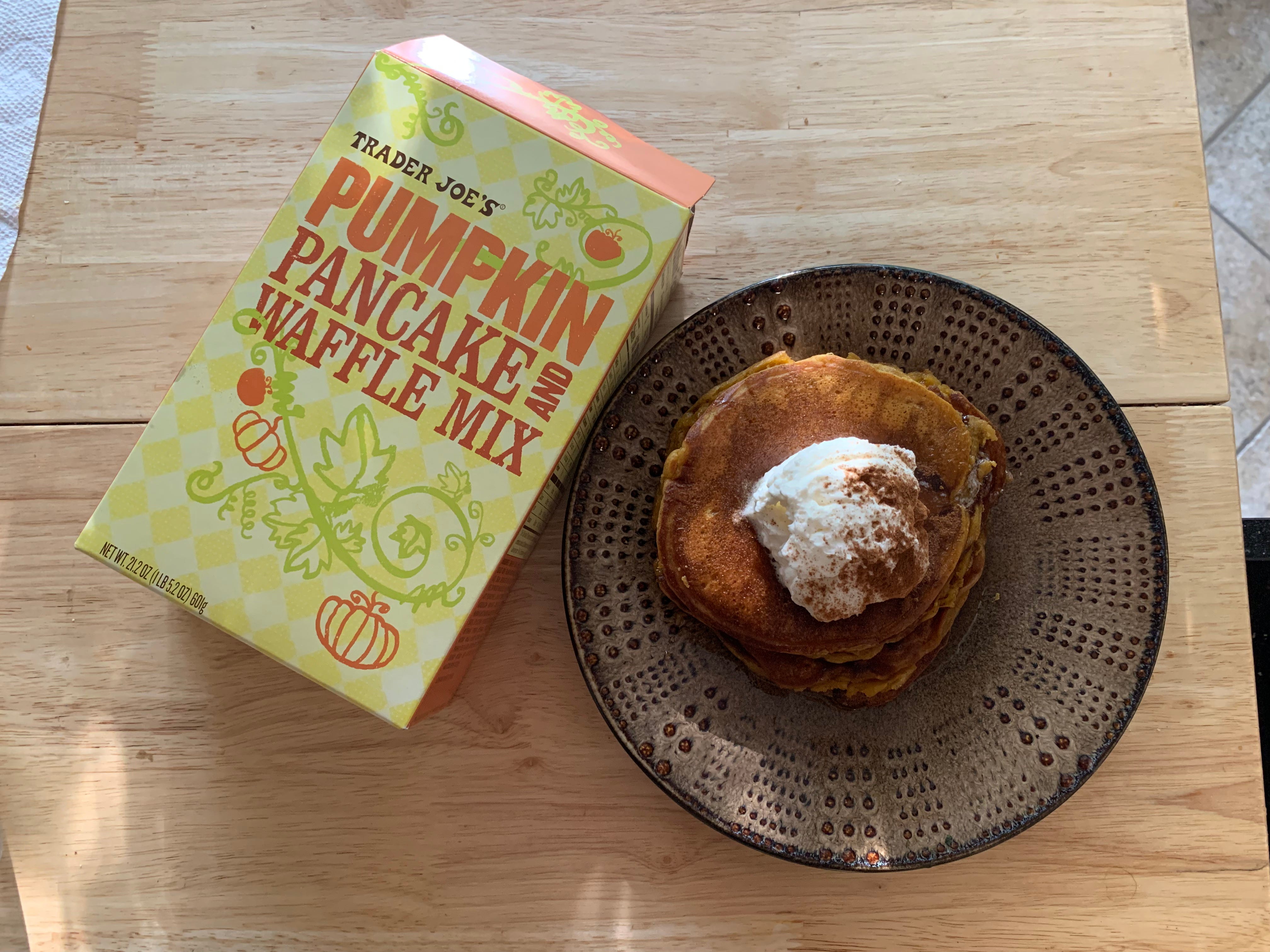 Trader Joe's pumpkin pancake mix box next to stack of pancakes