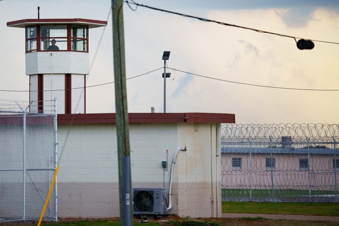 A color photograph of Angola prison with lookout tower in view