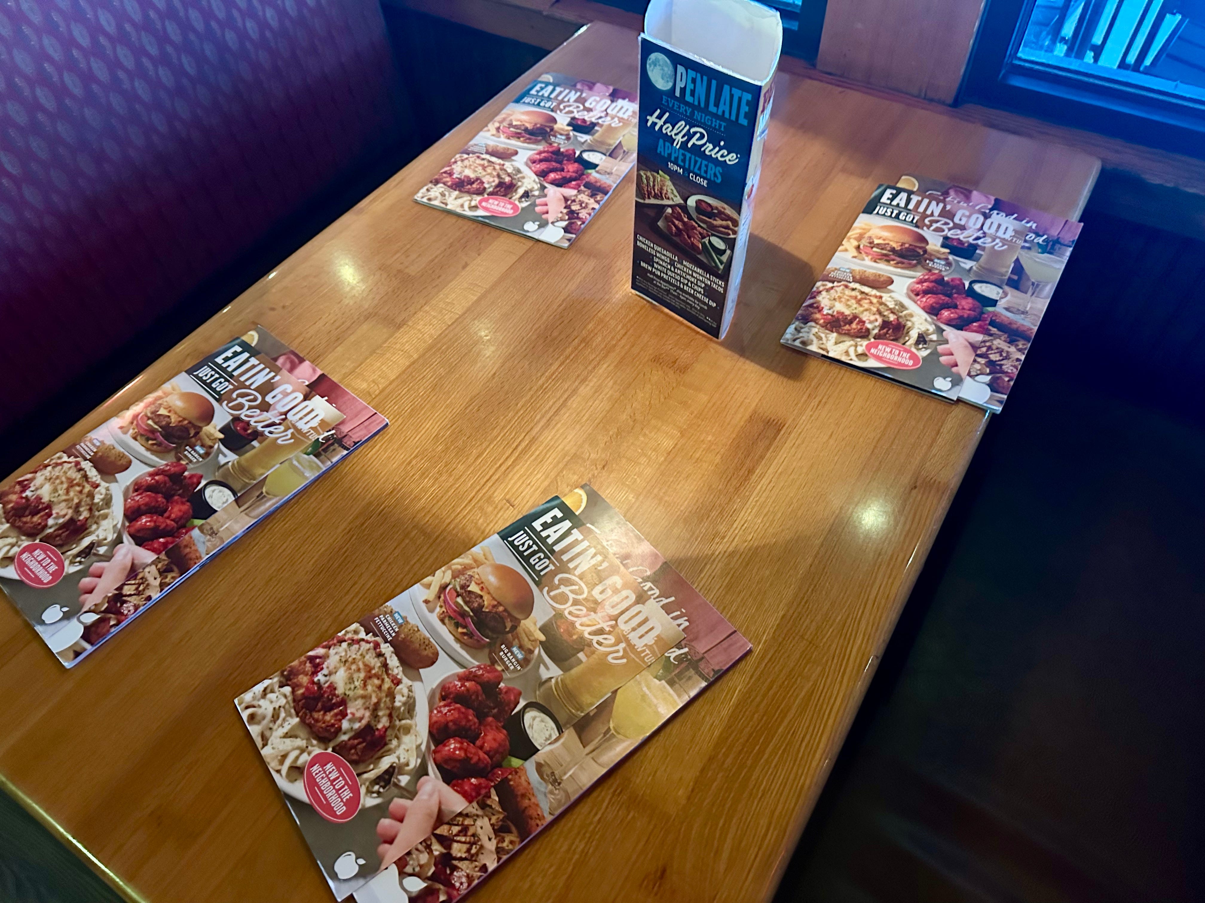 Table with menus on it at Applebees