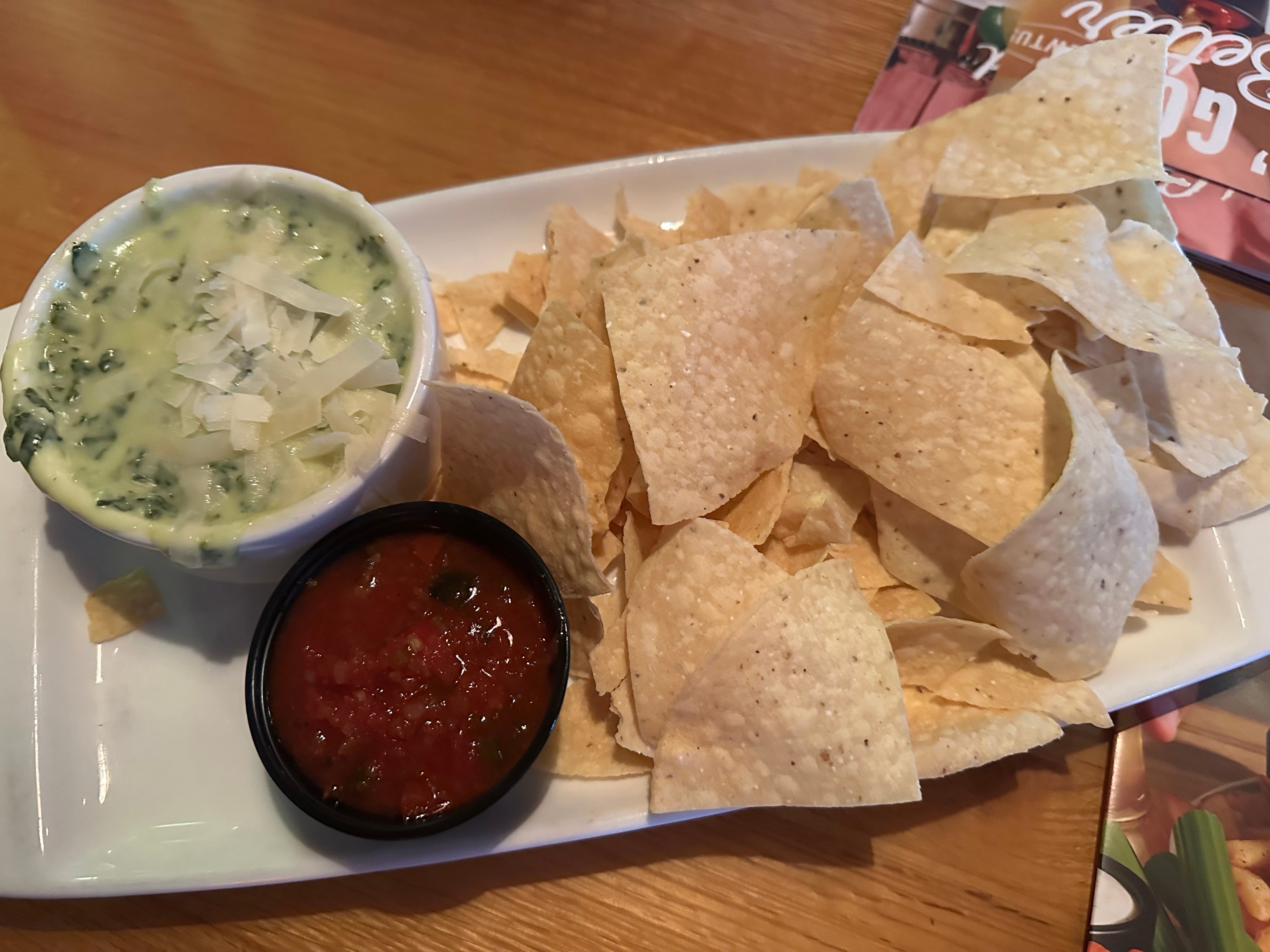 Tortilla chips with spinach and artichoke dip, salsa, at Applebees