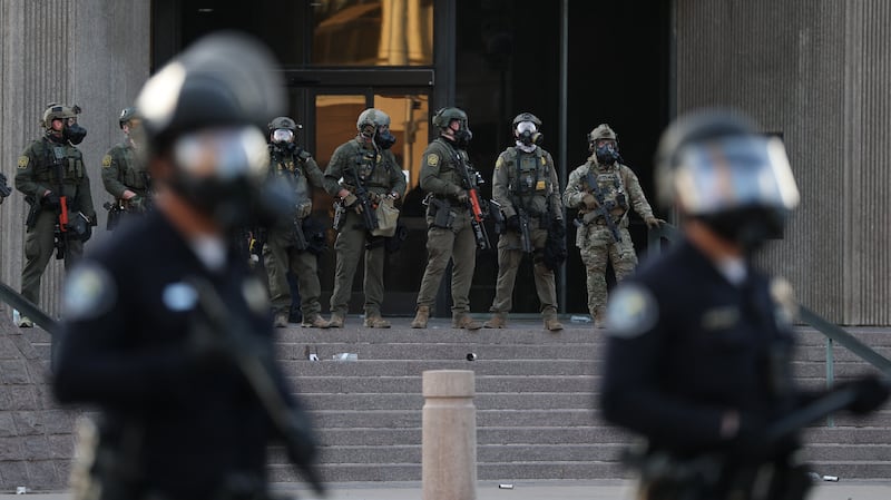 olice and US Customs and Border Protection agents outside the United States Citizenship and Immigration Services (USCIS) Santa Ana Field Office