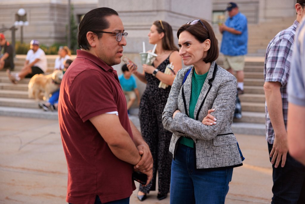 Peggy Flanagan speaking with a man.