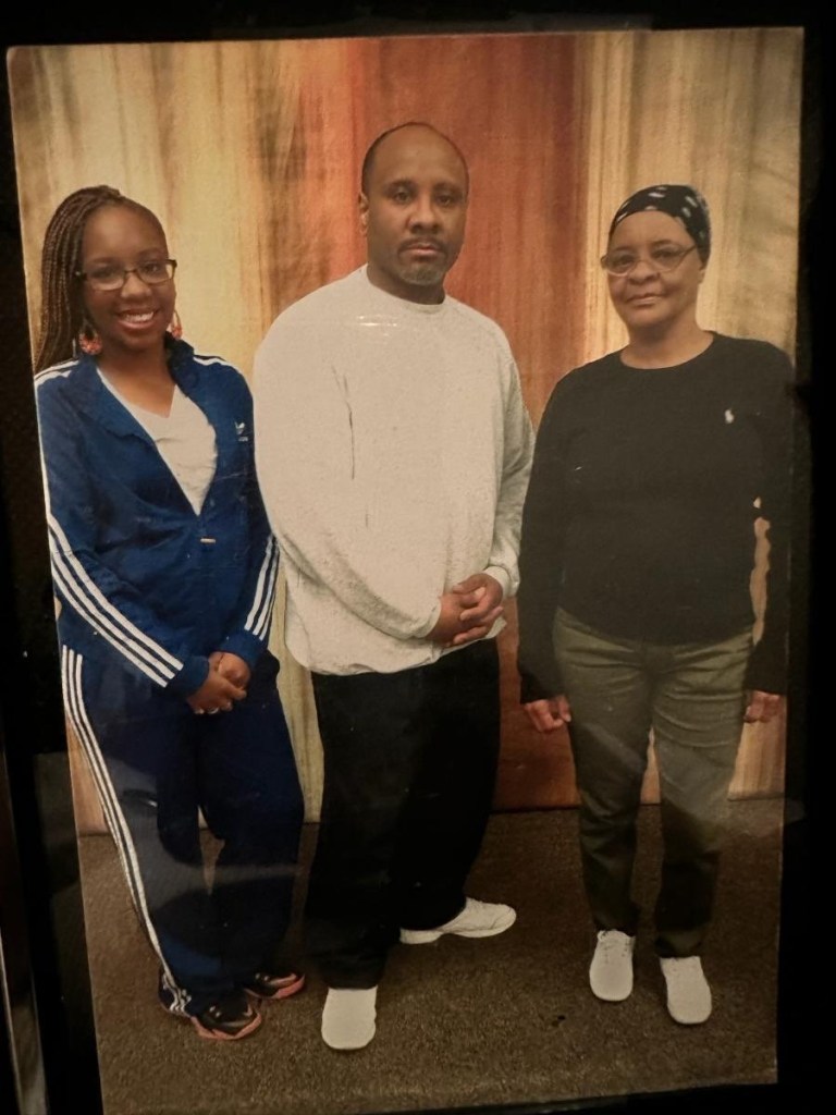 Photo of a family: a man, a woman, and a girl.