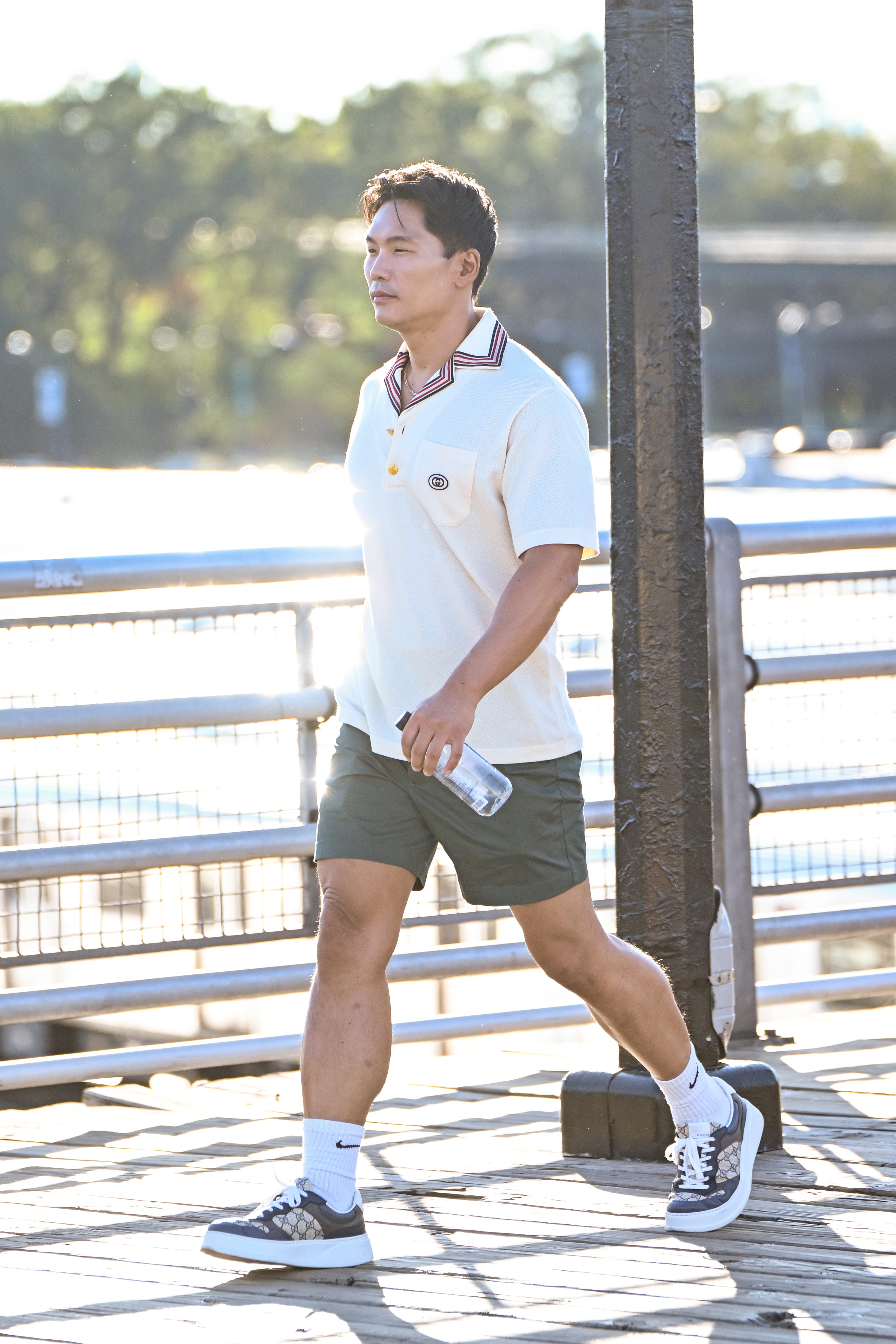 A man in green shorts and a white polo.