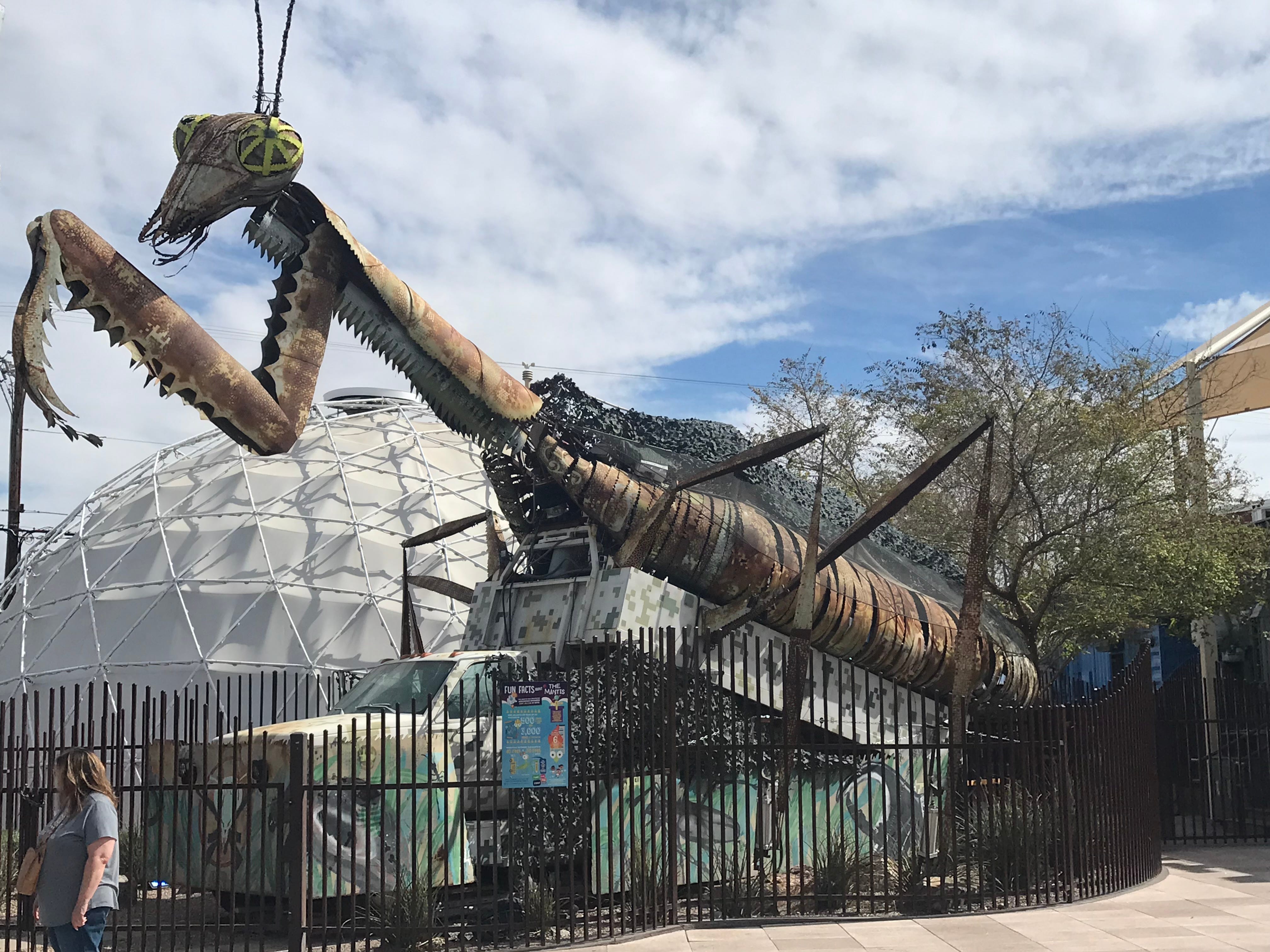 Large praying mantis statue at Container Park