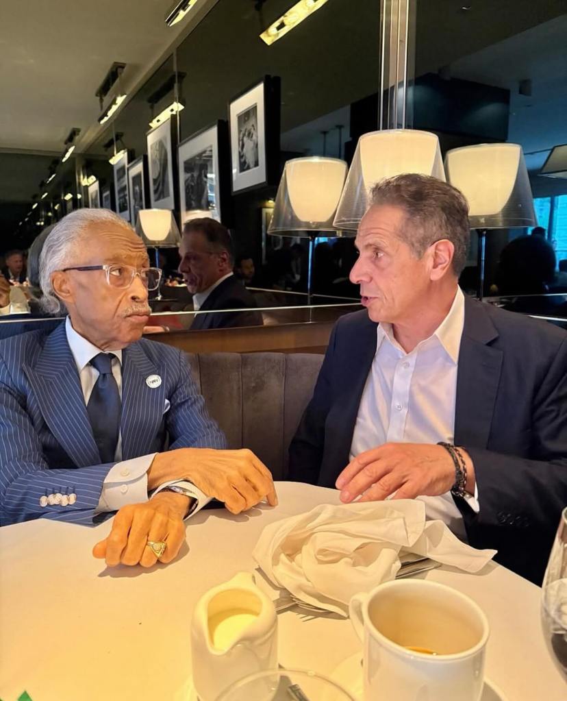 Gov. Andrew Cuomo and Rev. Al Sharpton having breakfast.