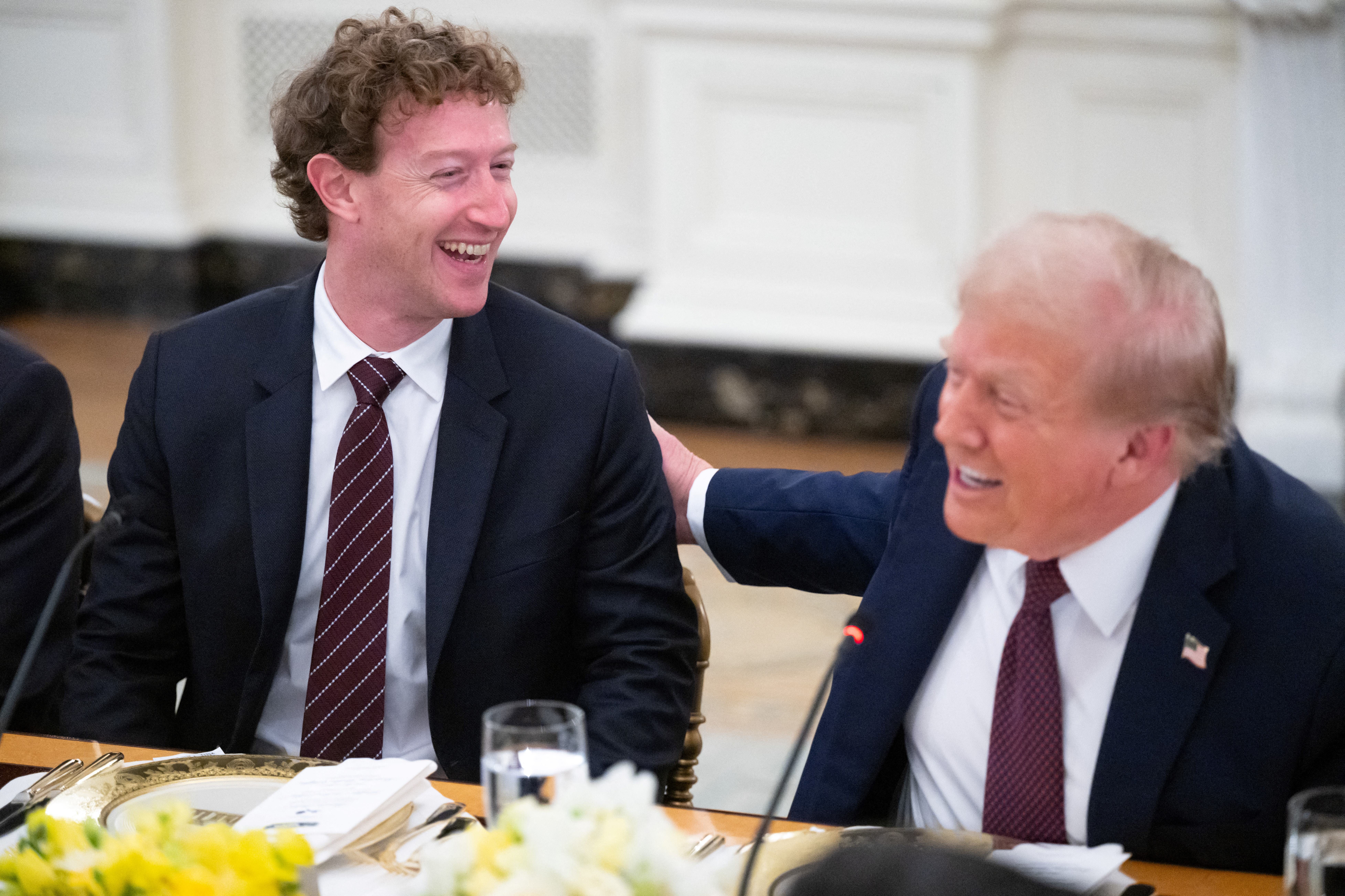 trmp patting mark zuckerberg on the back