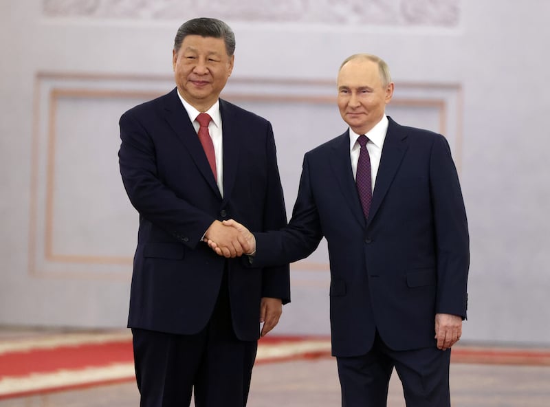 Russian President Vladimir Putin shakes hands with Chinese President Xi Jinping during a meeting at the Grand Kremlin Palace in Moscow on May 8, 2025.