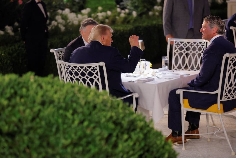 Donald Trump sits during a dinner for lawmakers on the newly renovated Rose Garden patio, at the White House.