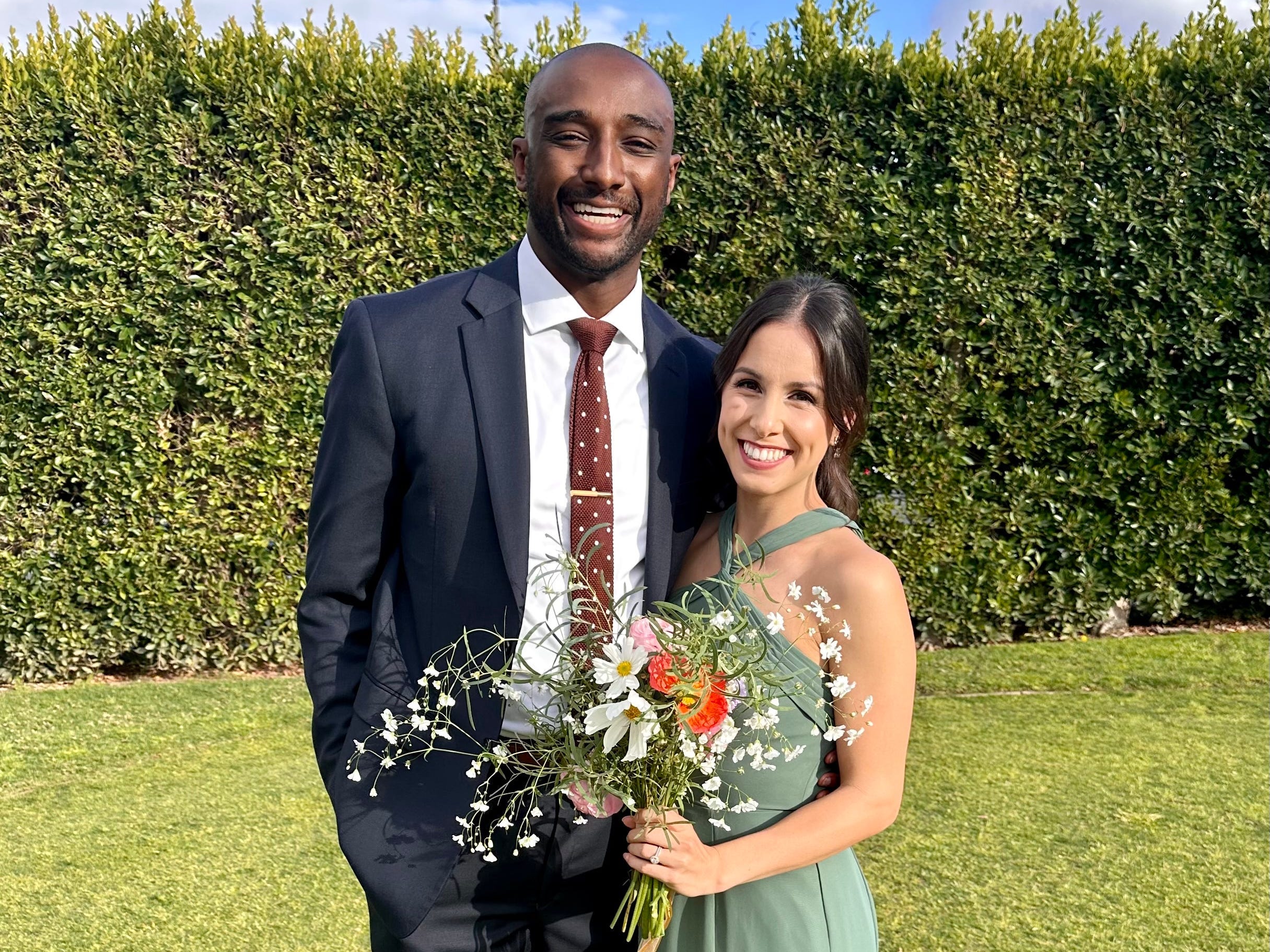 Couple pose for picture in grass field