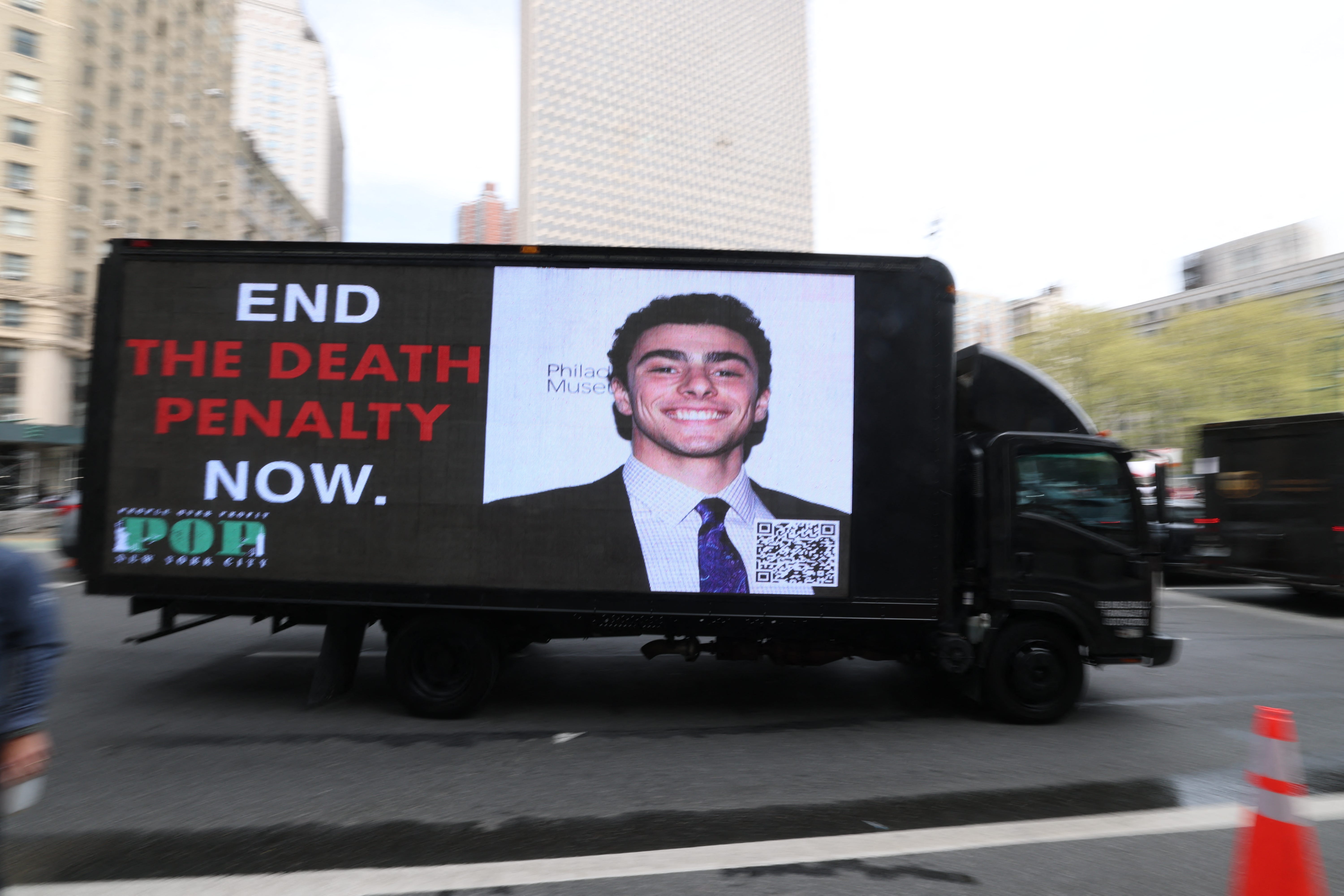 A digital billboard truck circles federal court in Manhattan during his April 2025 arraignment. Its sign reads "End the death penalty now."