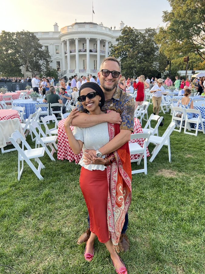 Tim Mynett and Ilhan Omar embracing in front of the White House.