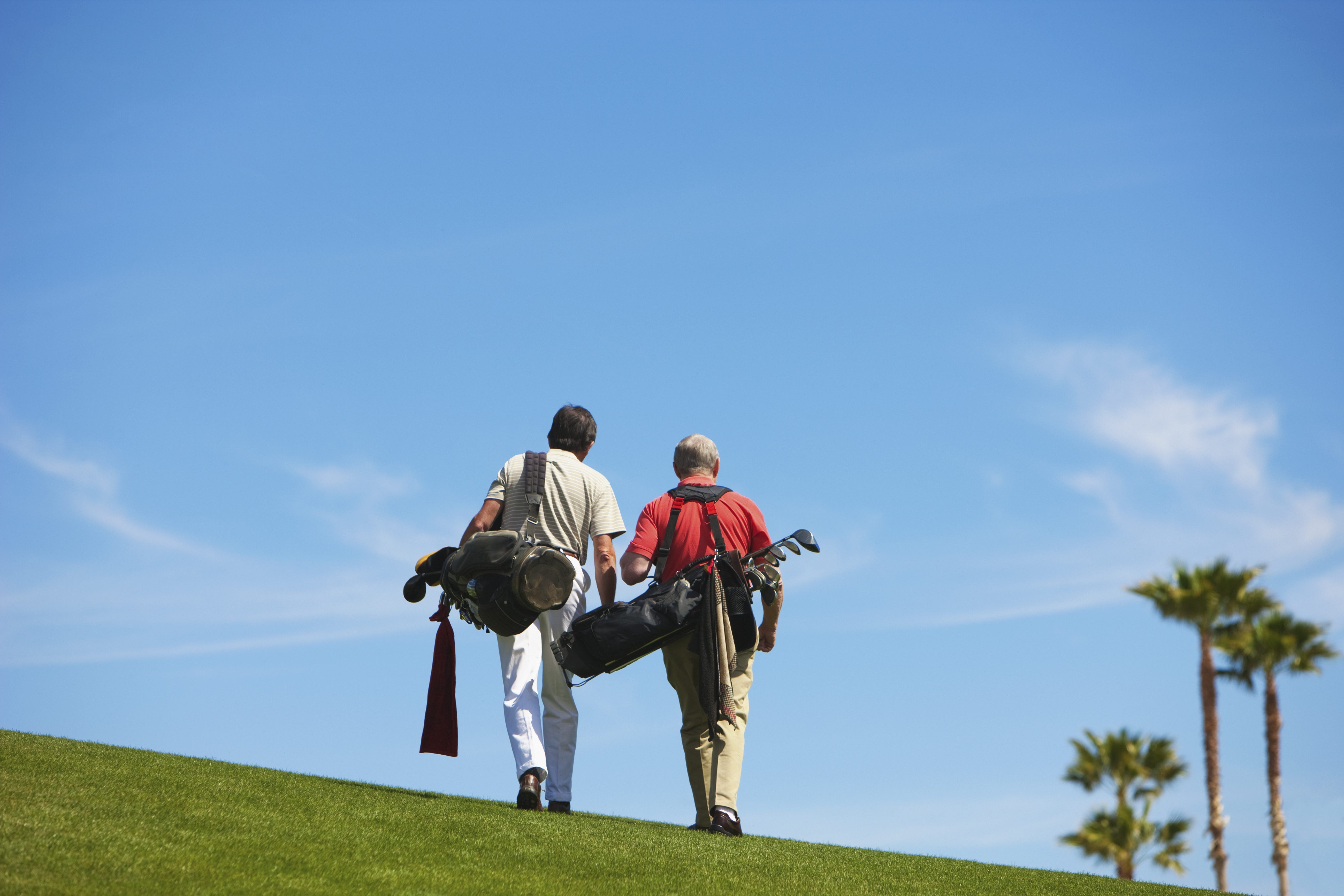 Older men walking on golf course