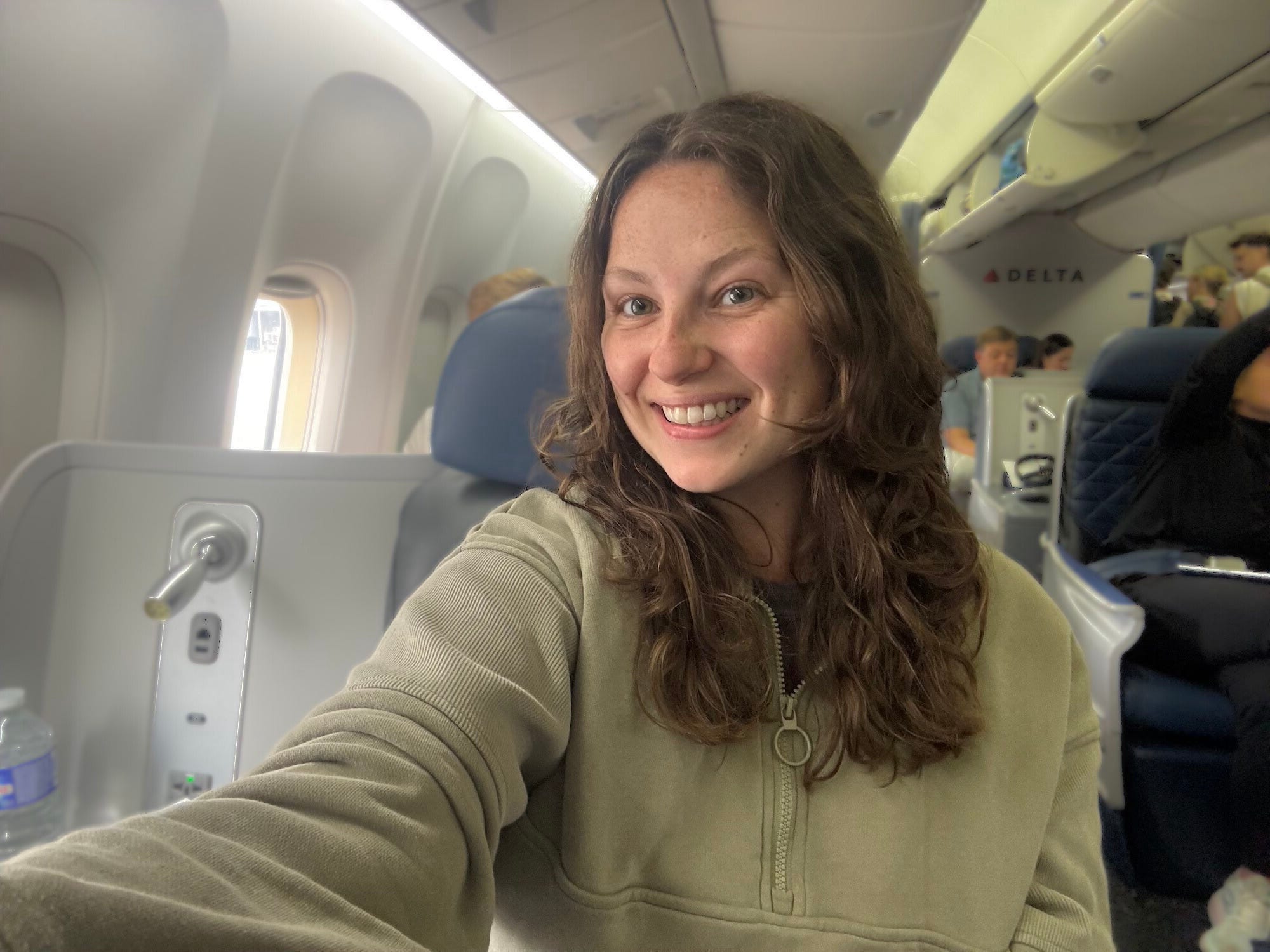 A selfie of a woman on a Delta plane.