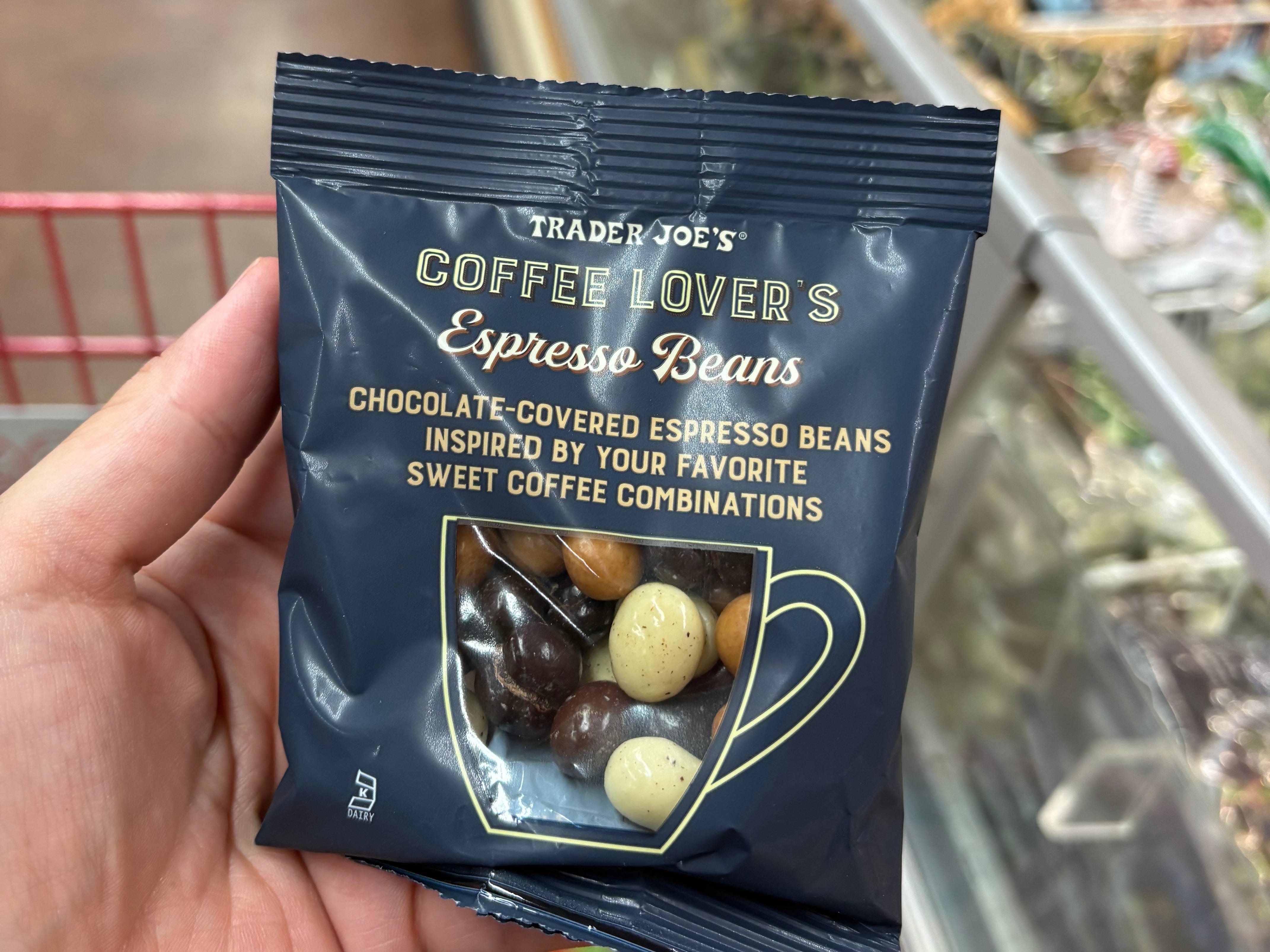 The author holding a pack of Trader Joe's coffee lover's espresso beans.